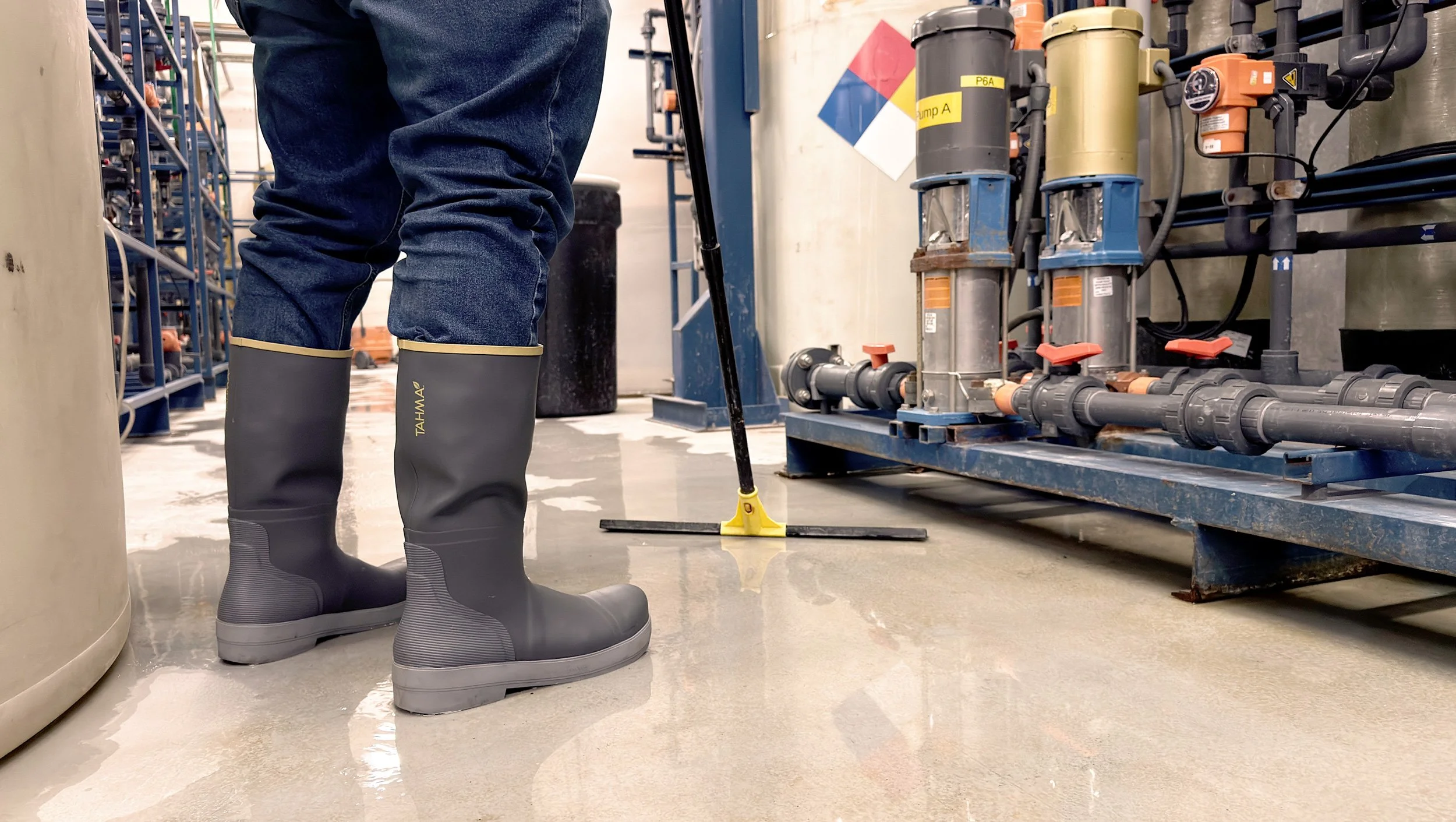 Tahma boots worn by worker with squeegee at a water treatment facility