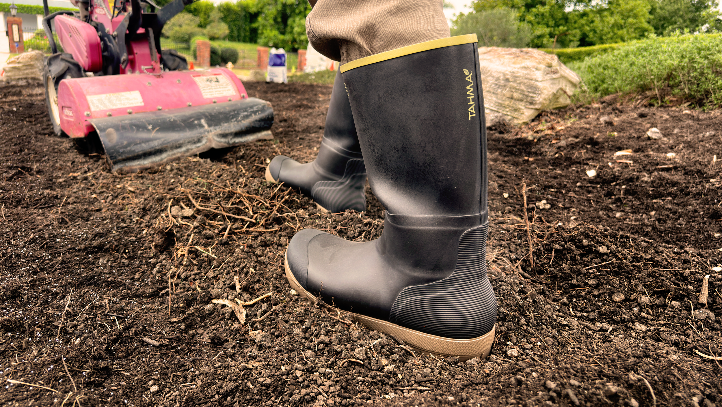 Tahma All Terrain Boots worn by a landscaping pushing a rototiller on dirt