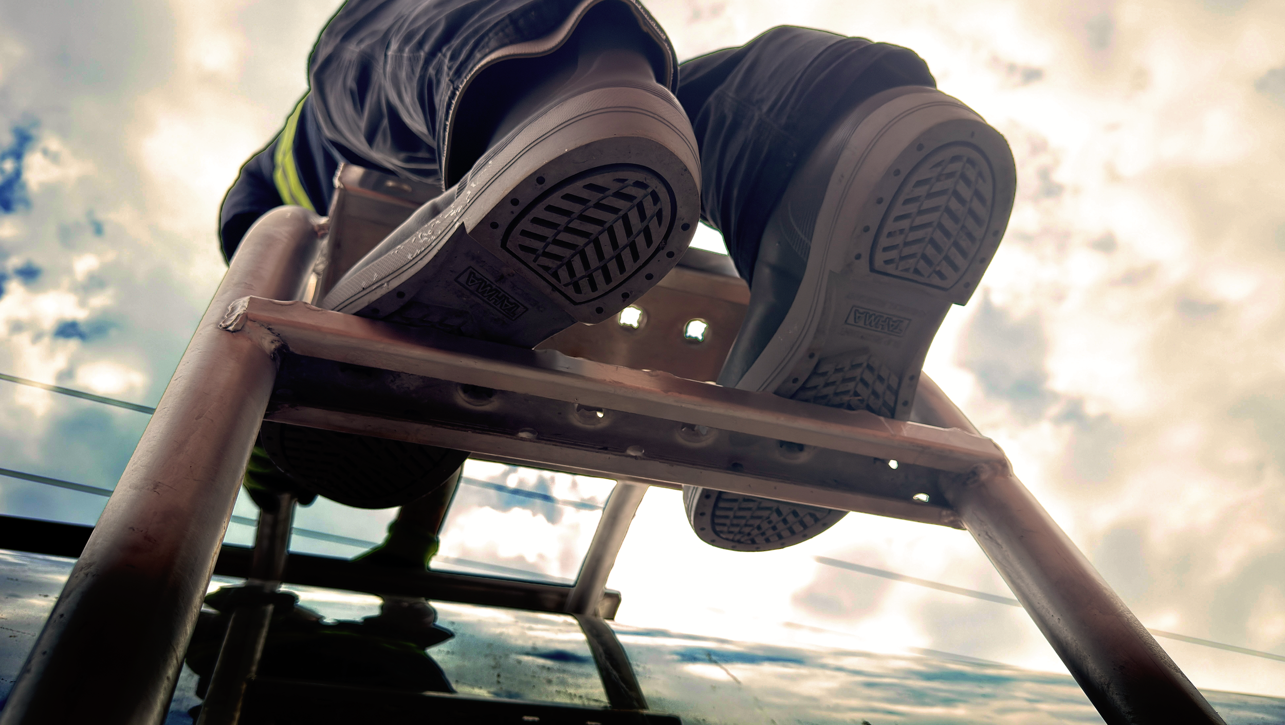 Tahma 15 tall boots on a truck trailer ladder