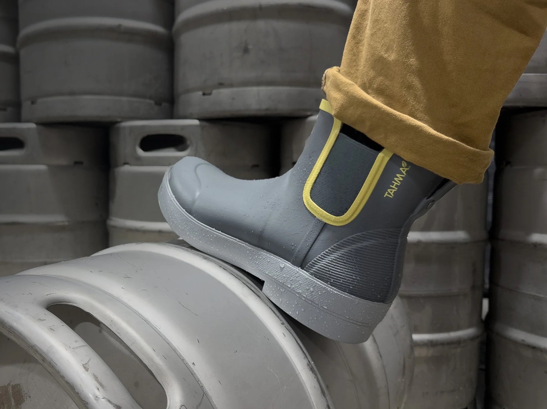 Tahma Low-Cut boots stepping on a keg at a brewery