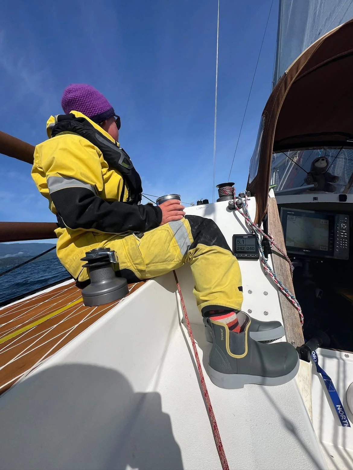 customer wearing low-cut Tahma boots while on a sailboat race to Alaska