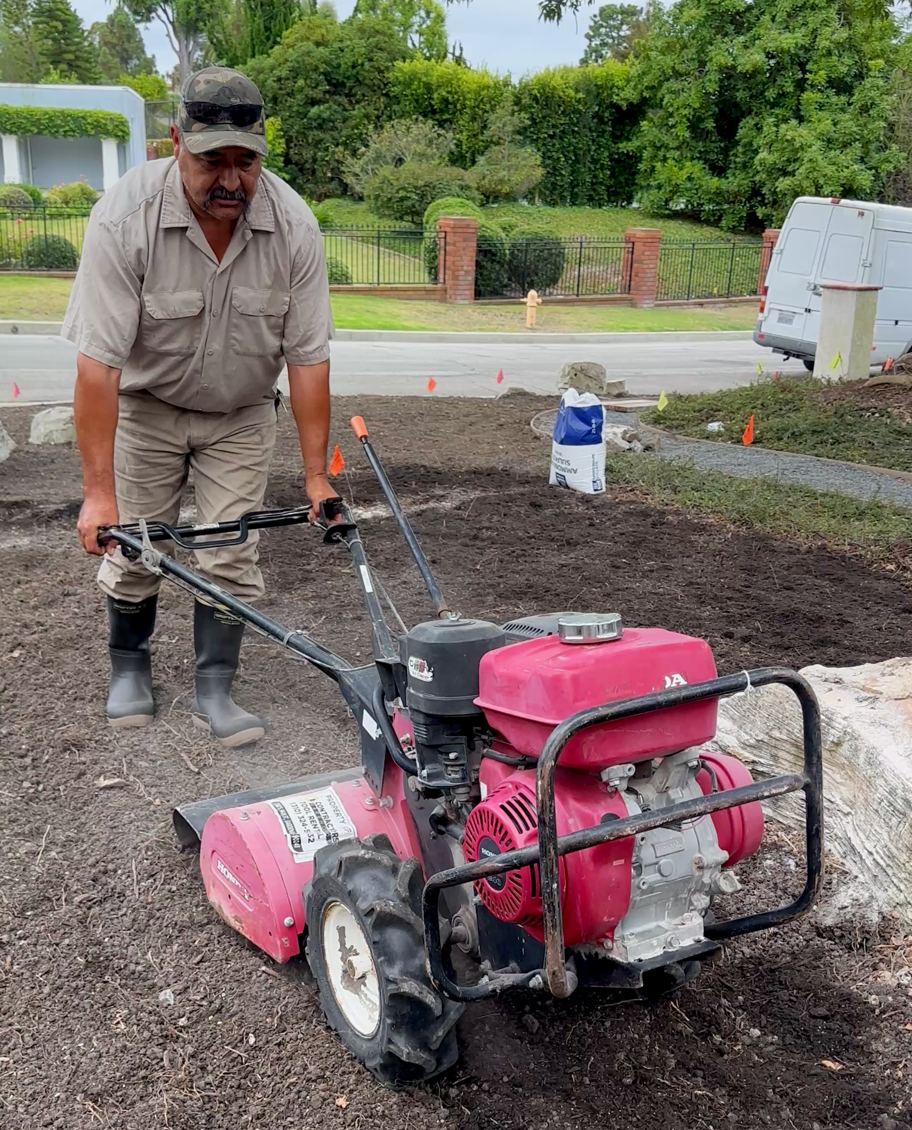 Landscaper wearing Tahma All Terrain boots using a rototiller