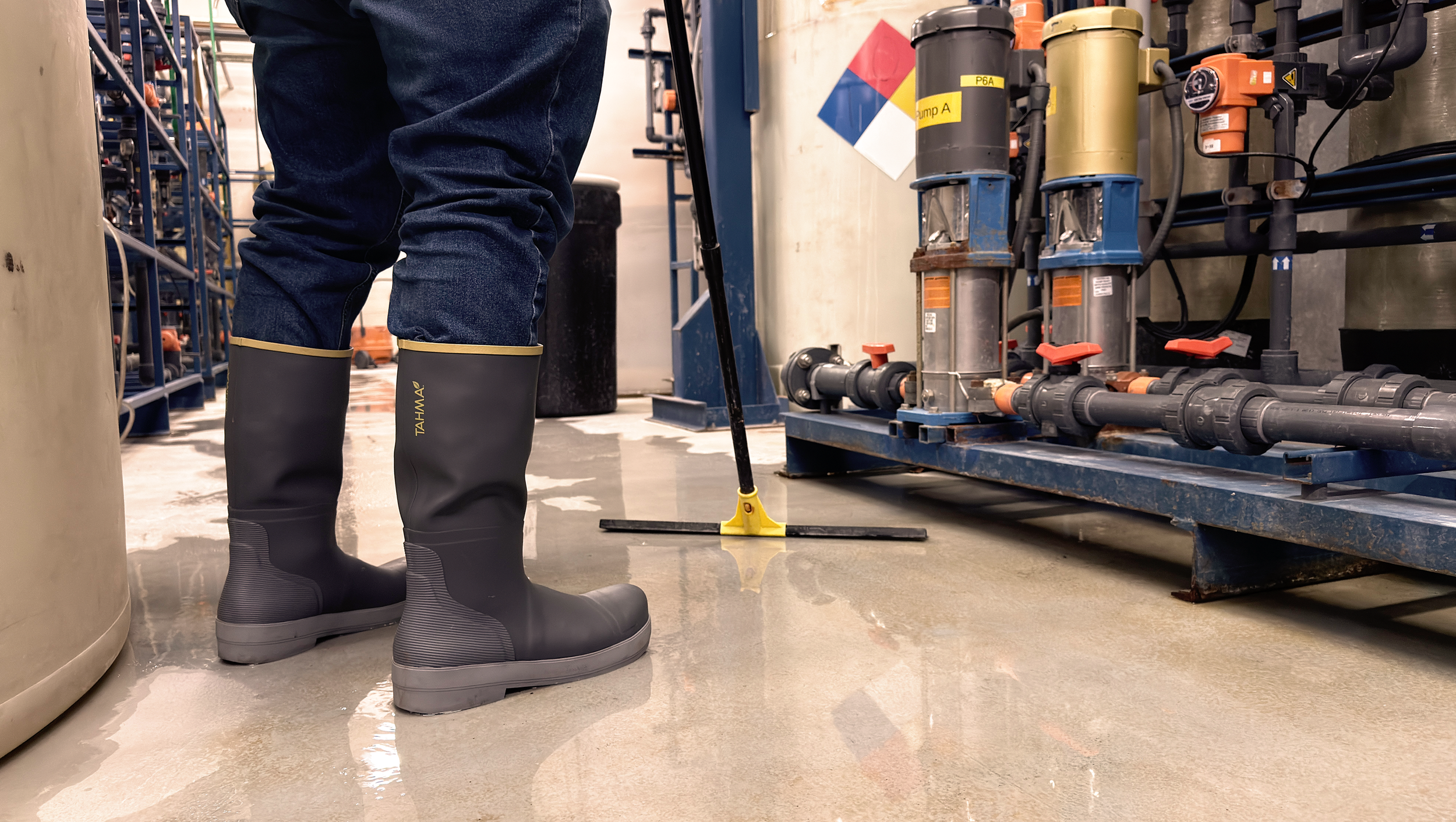 Tahma boots worn by worker with squeegee at a water treatment facility