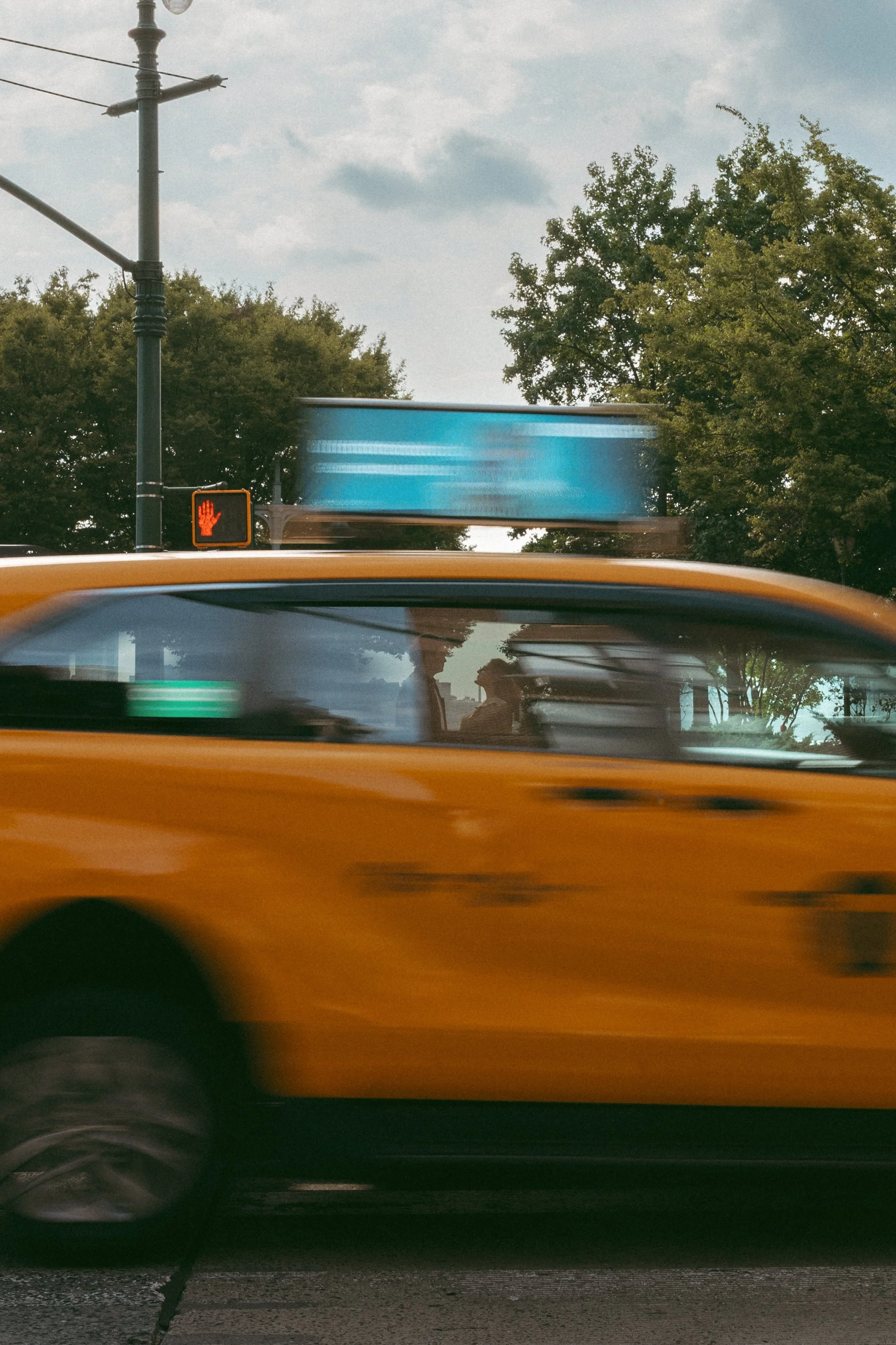A woman with a wedding ring on her finger and a man with a wedding ring, holding hands on a white surface.