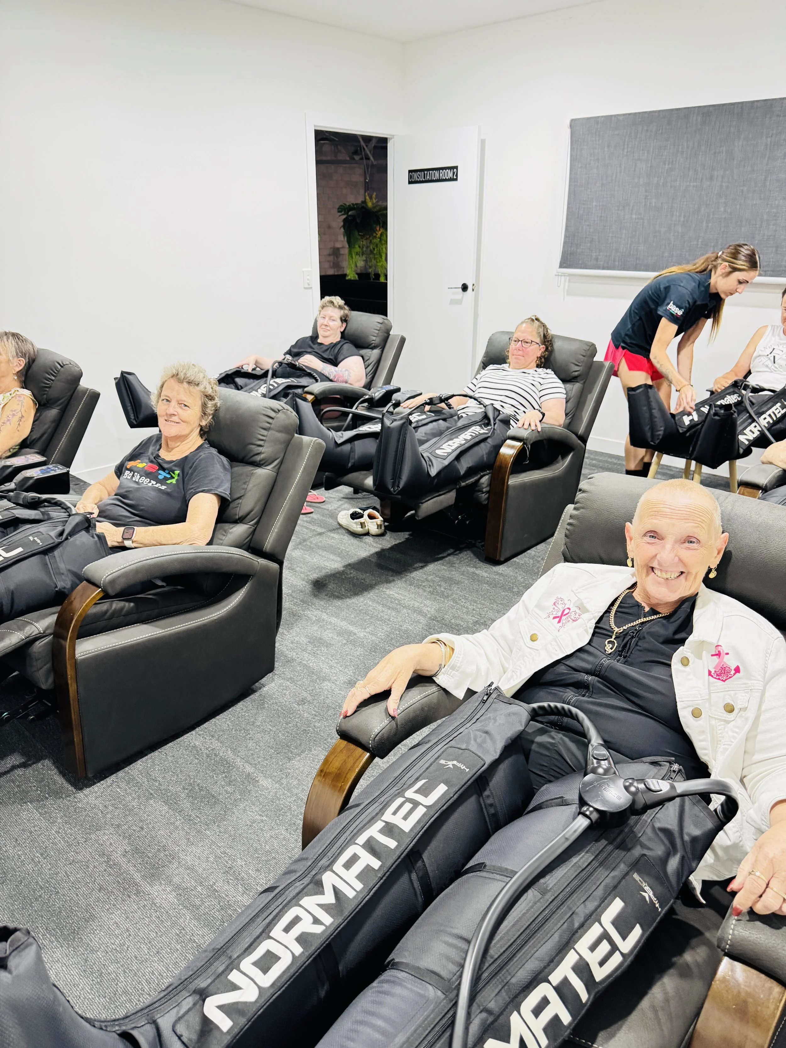pinkco-group-two-attendees-normatec-treatment.jpeg
