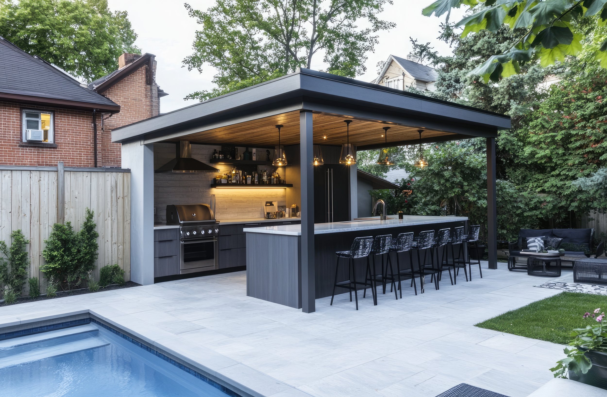 Modern outdoor pergola with bar seating beside pool. Luxury entertaining space by Cascades Dallas.