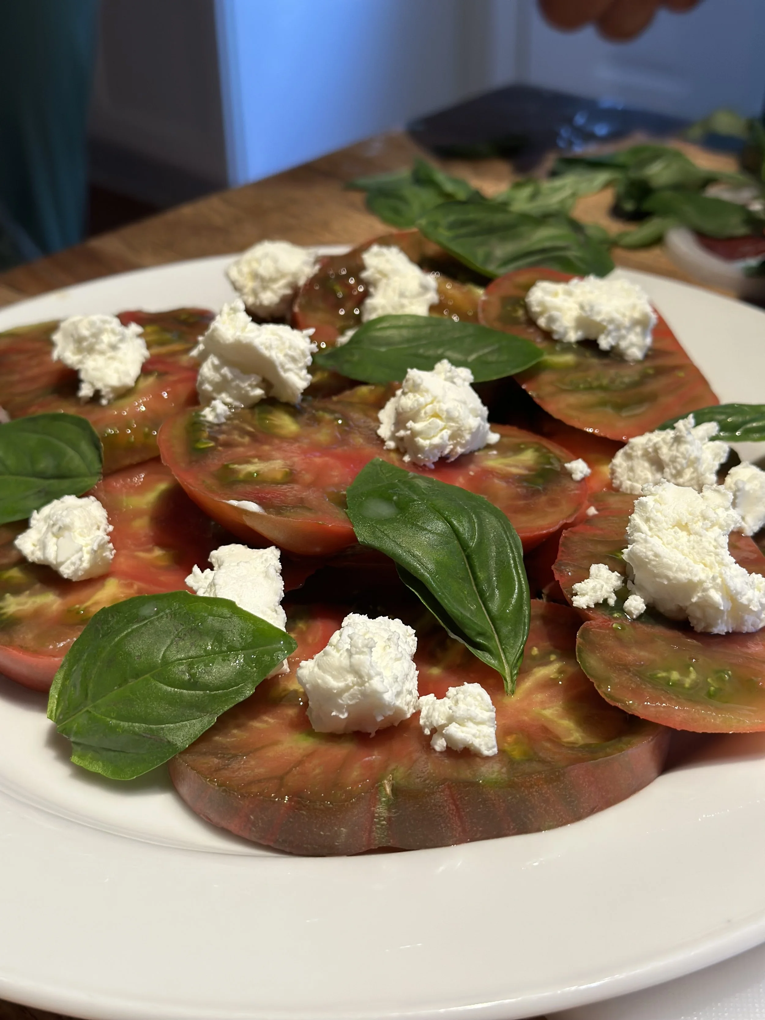 Heirloom tomatoes and fresh chèvre from just two miles down the road at White Lotus Farms. True Farm-to-Table.