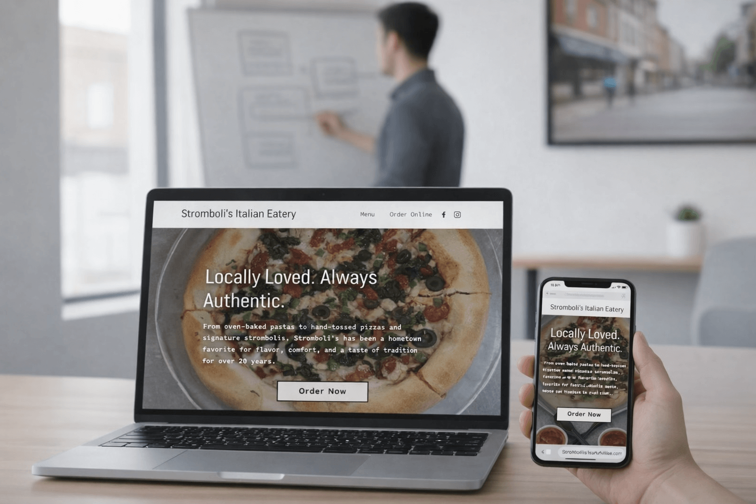 Modern bakery website shown on laptop and phone in office setting — highlighting Lazyguys professional web design for Mississippi restaurants.