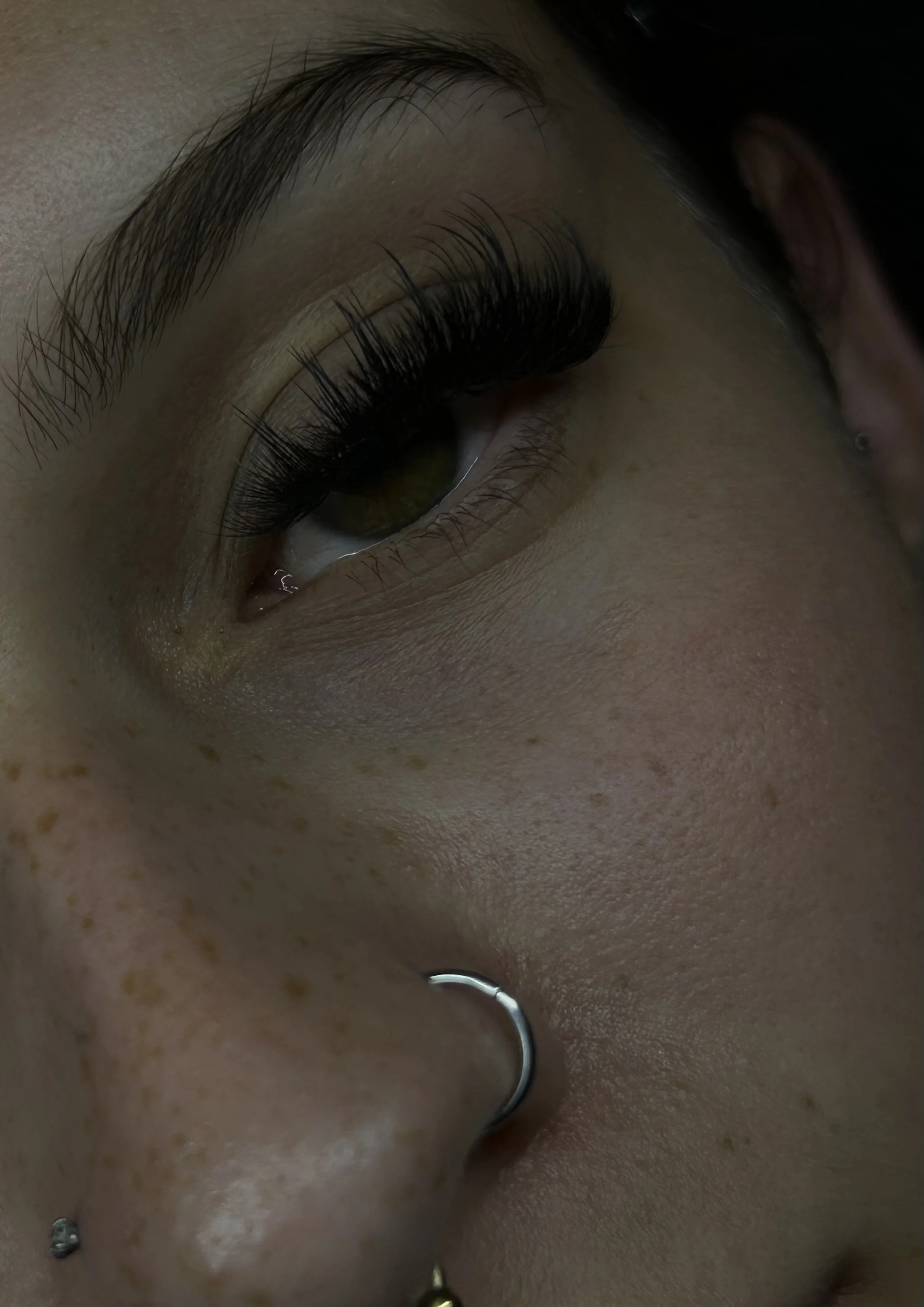 Close-up of a person's face, focusing on the eye with long, dark eyelashes by Priori-Tea Coffs Harbour.