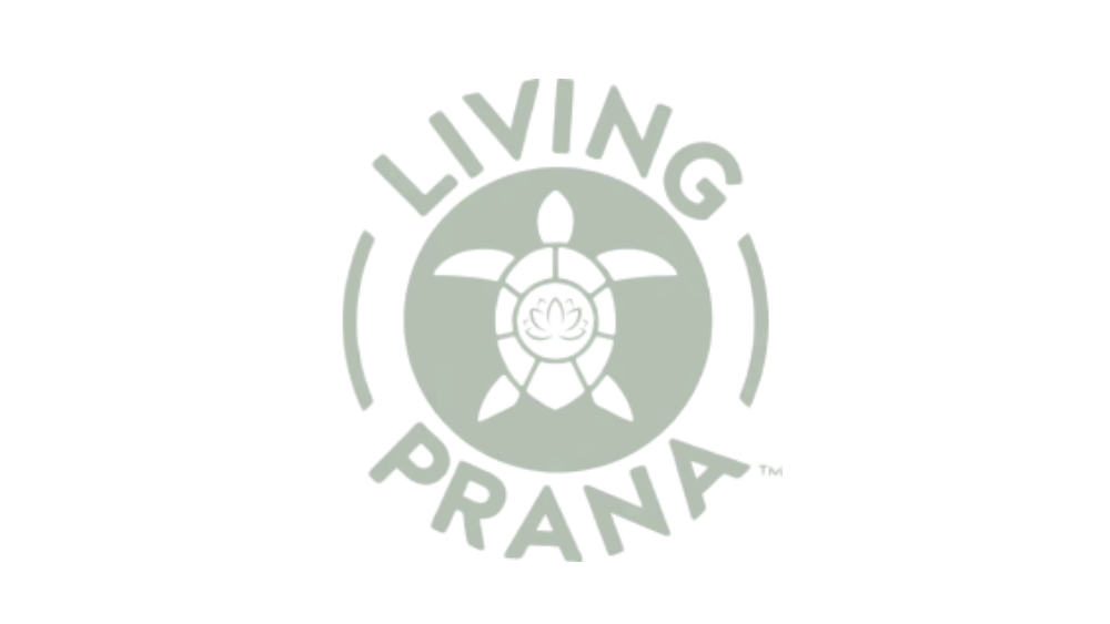 A circular logo with a truck in the center, surrounded by the text 'LIVING PRANA' around the top and bottom.