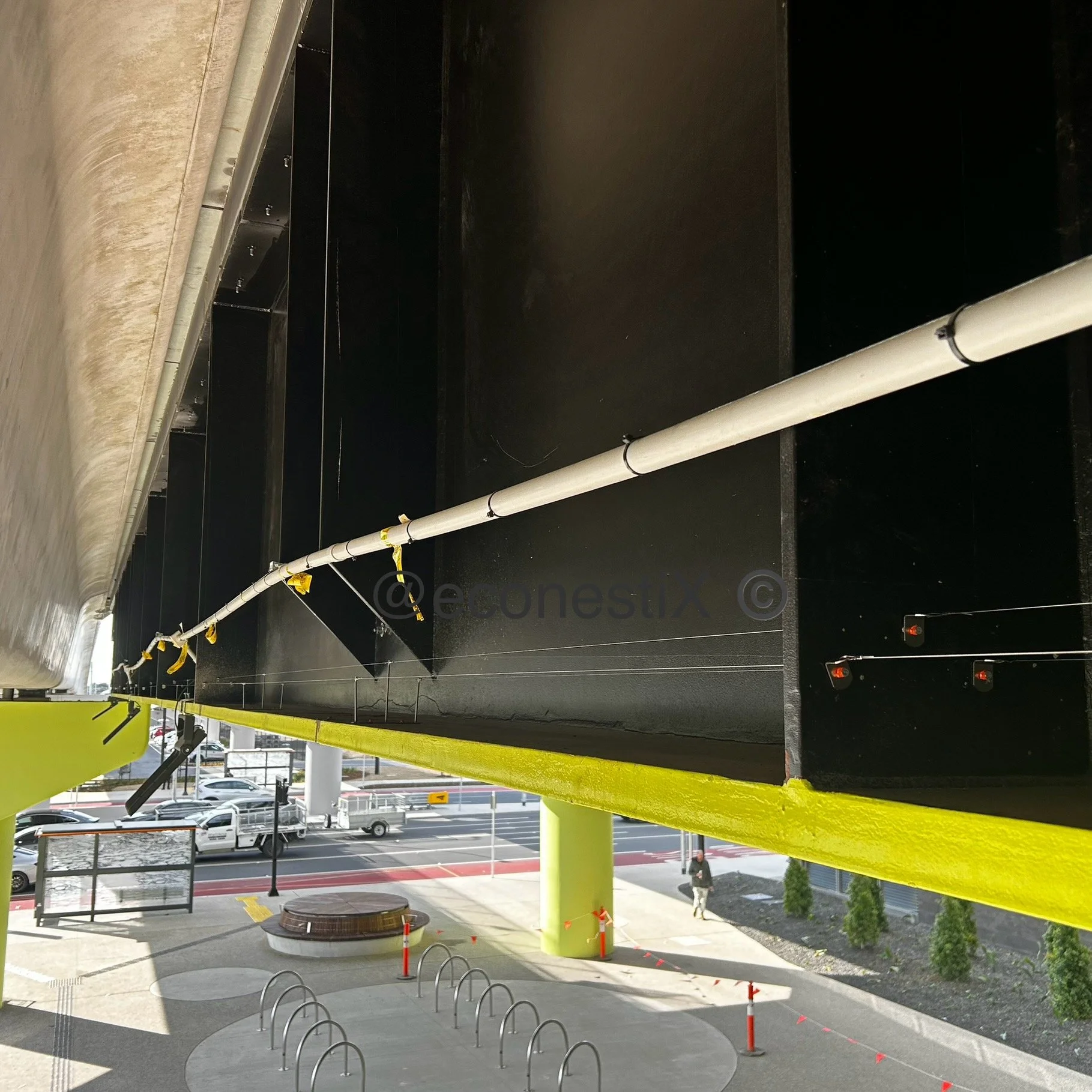 Large under railway beam has been fitted with stainless steel bire wire to prevent birds from perching and siling the passengers and station below. very minimalist yet effective solution to perching birds suited to architectural applications.