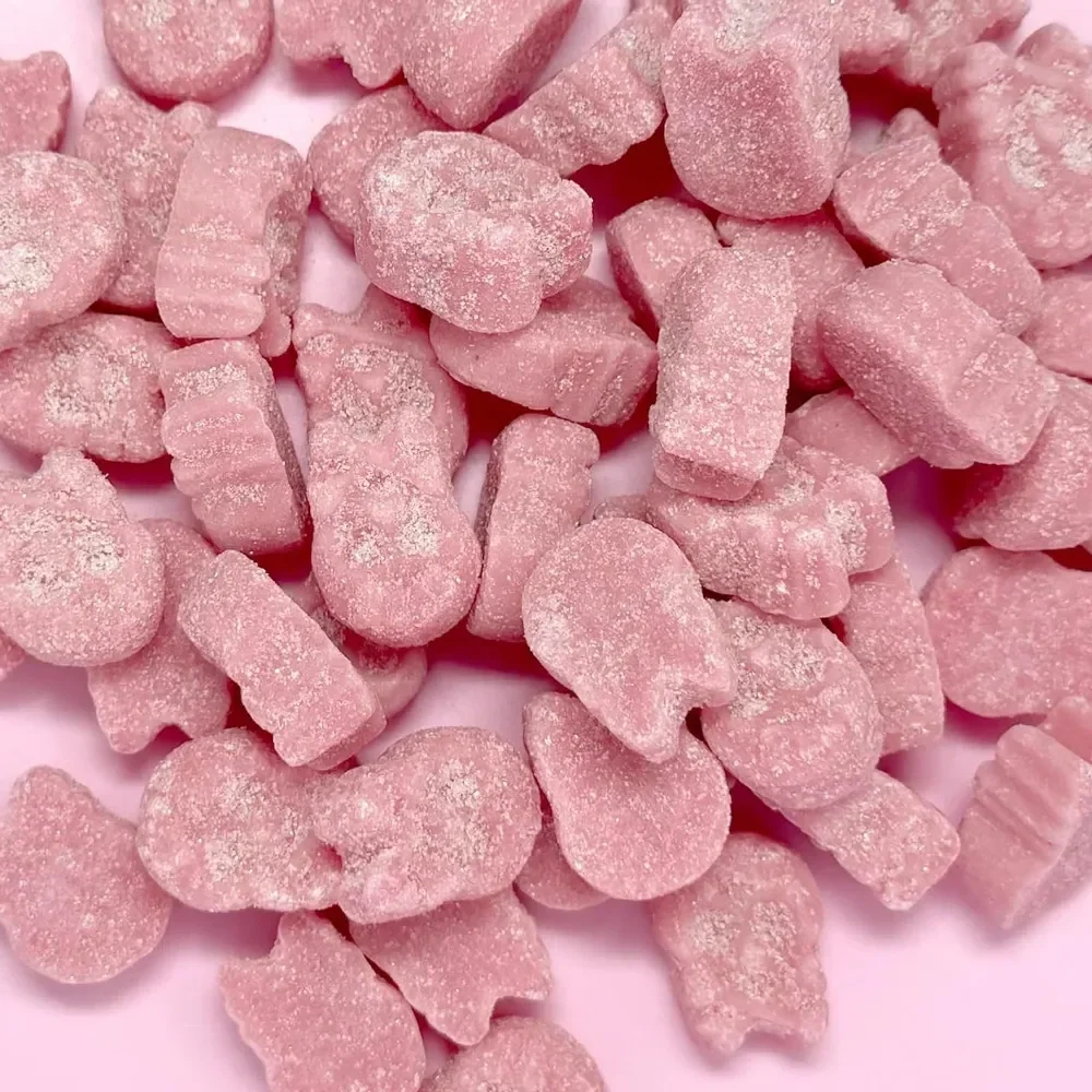 Close-up of Sugarloo World Swedish Mini Skulls Sour Raspberry vegan gummy candy featuring soft pink, sugar-dusted skull-shaped gummies with a bright, tangy sour coating and chewy texture.