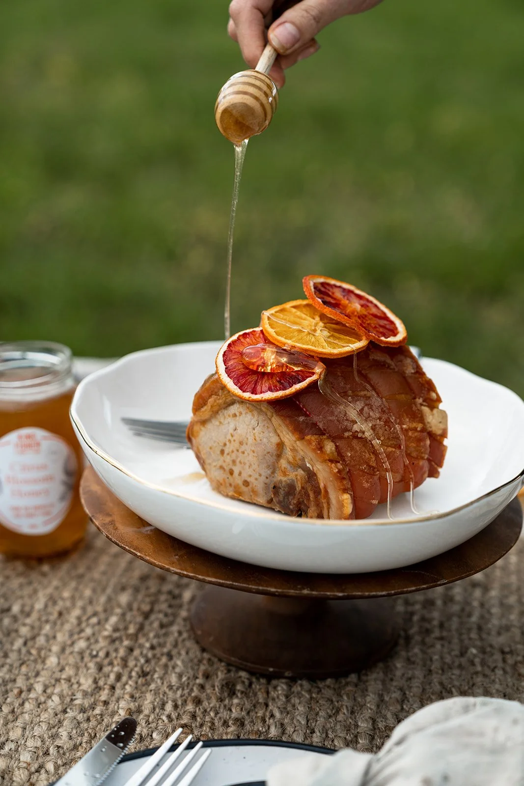 A glazed ham topped with brightly coloured dehydrated Kingfisher orange slices, drizzled with honey.