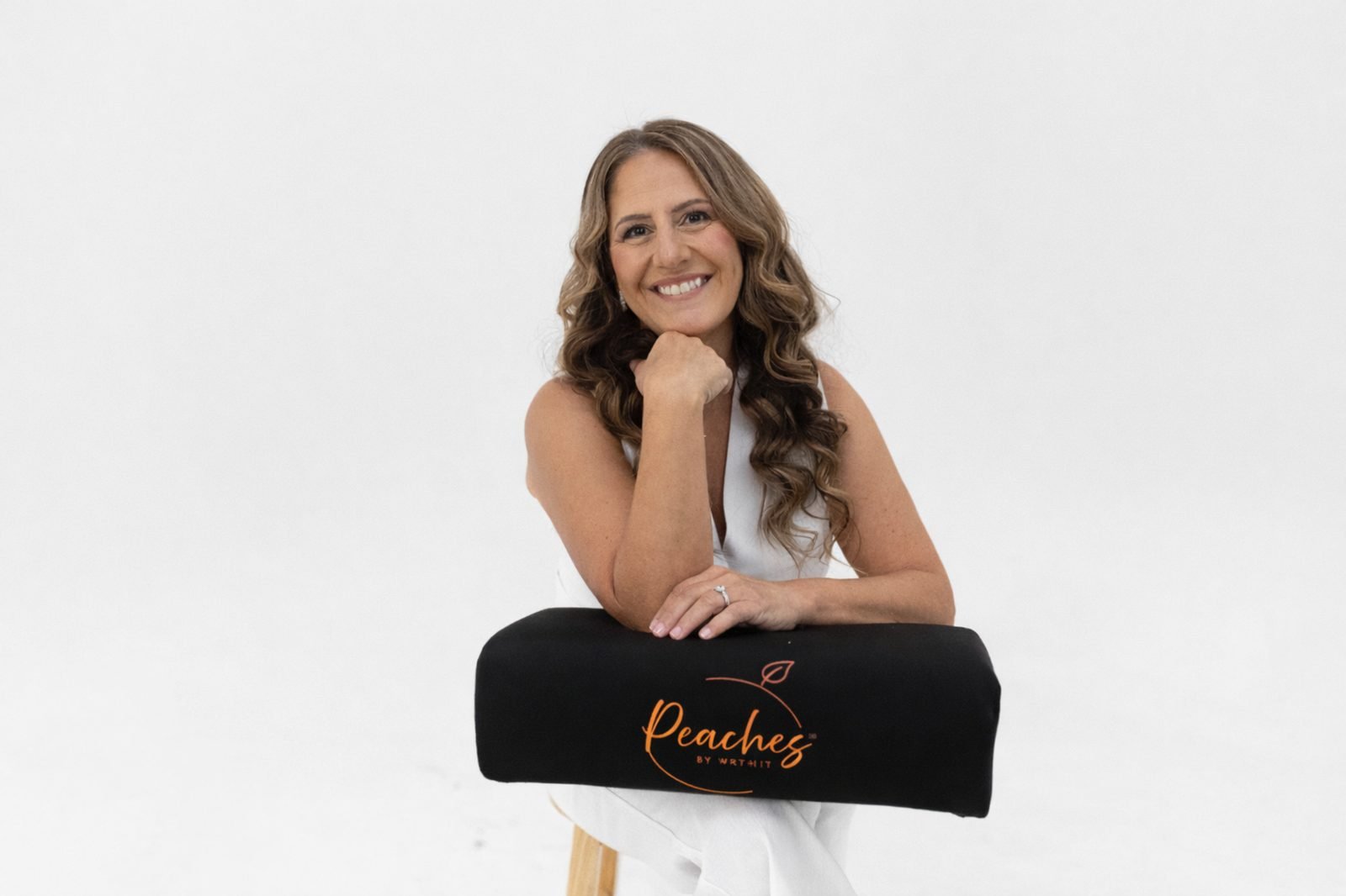 Monica Skalsky posing with The Bellini BBL Pillow from Peaches by Wrthit