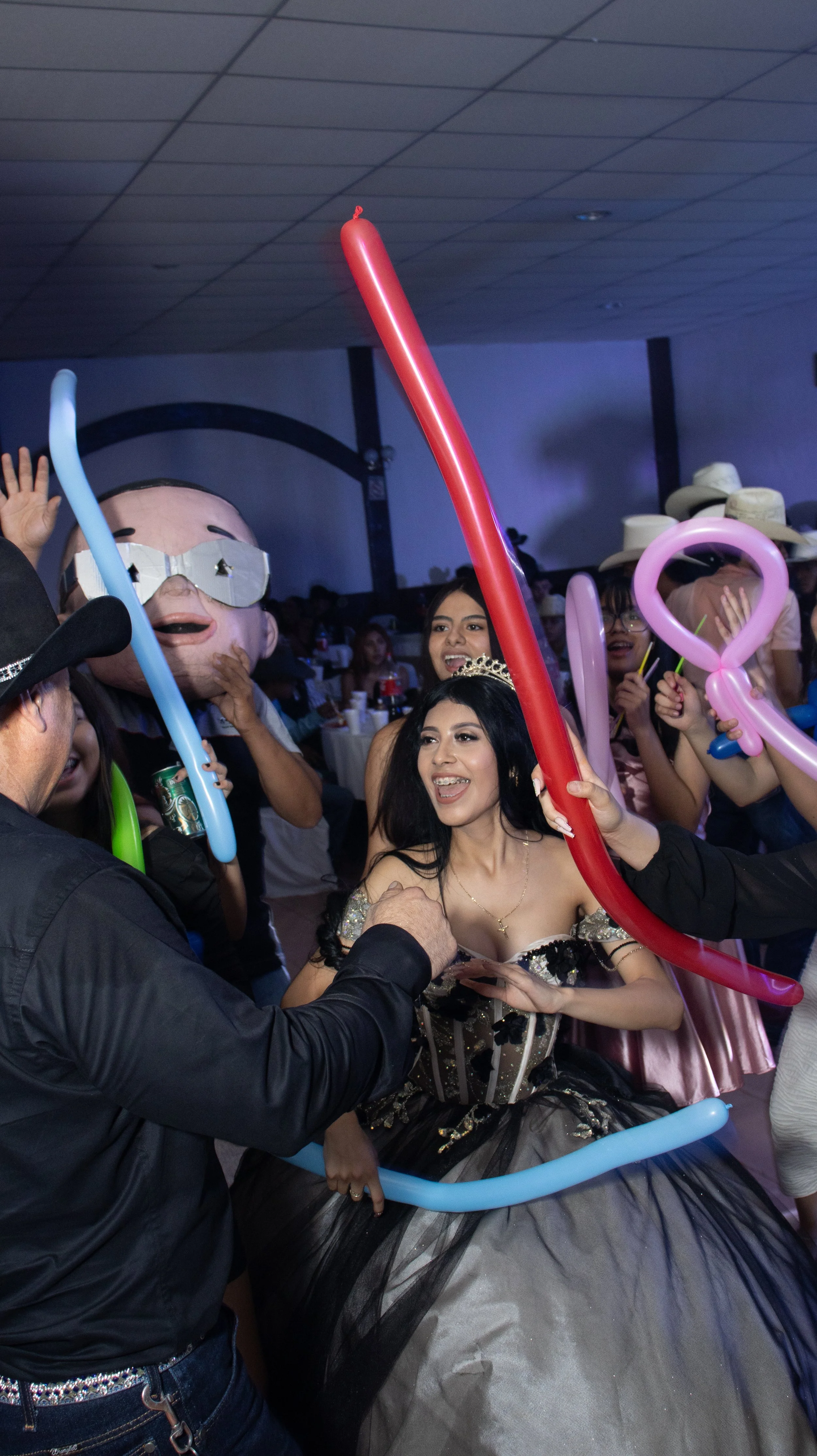 Capturamos la energía del momento con encuadre cercano y velocidad de obturación adecuada para congelar gestos y globos. La luz de fiesta añade destellos que transmiten ambiente y alegría espontánea.