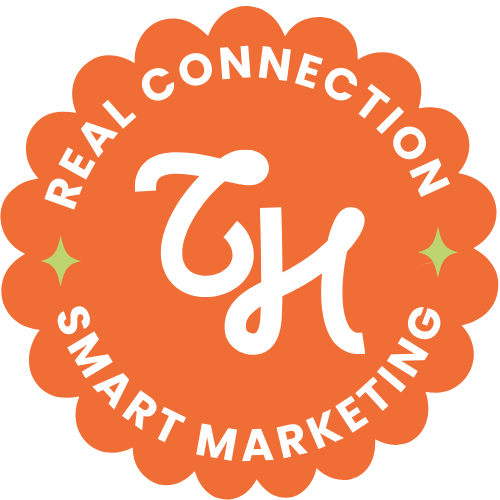Orange scalloped badge with white text that says "Real Connection, Smart Marketing" and a white stylized letter 'H' in the center, with two small green stars on either side.