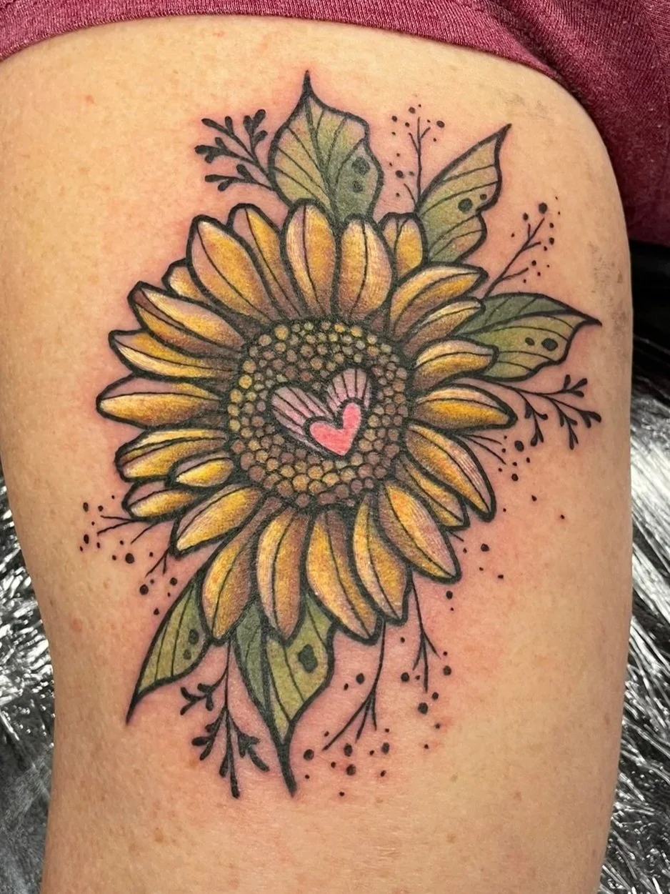 Tattoo of a sunflower with bright pigmented colors, tattooed by Zing Phelps in Cedar Rapids, Iowa