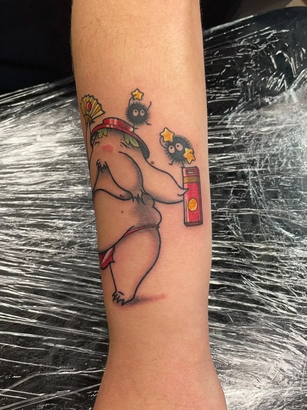 best tattoo shops near me, Zing Phelps, created this tattoo in Cedar Rapids, Iowa, it depicts the radish man from spirited away, holding a bath token and soot sprites