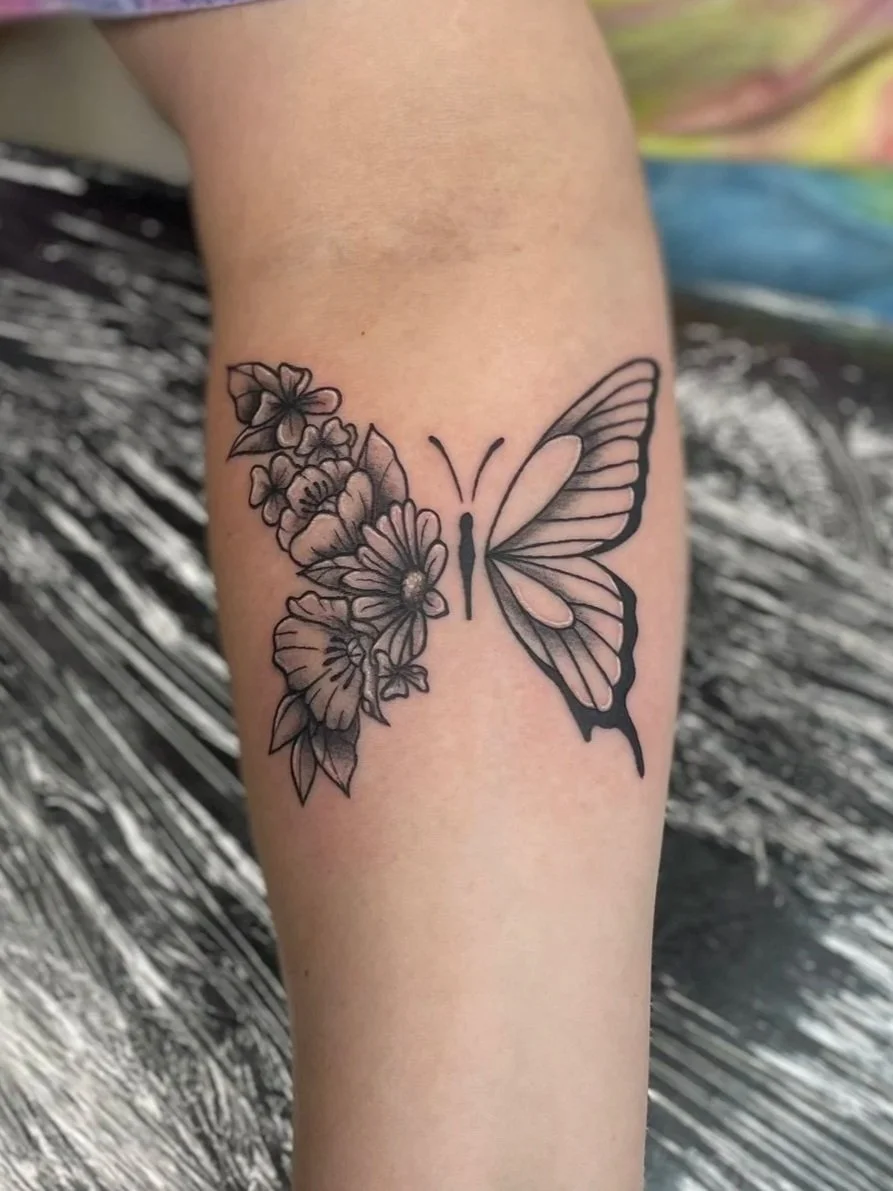 Tattoo of a butterfly with half floral details, tattooed by Zing Phelps, in Cedar Rapids, Iowa