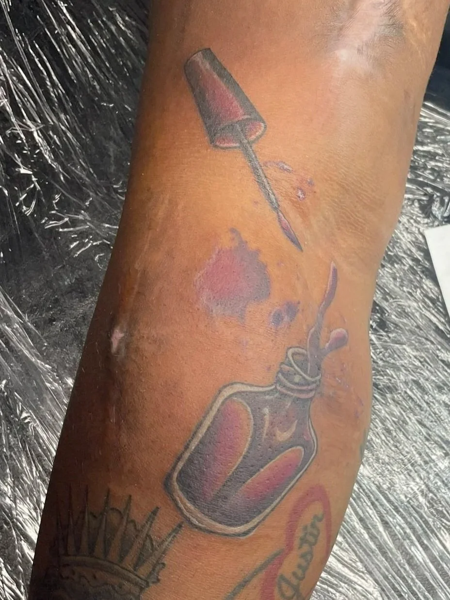 tattoo of a spilling jar of nail polish, purple watercolor splashes, tattooed by Zing Phelps, in Cedar Rapids, Iowa