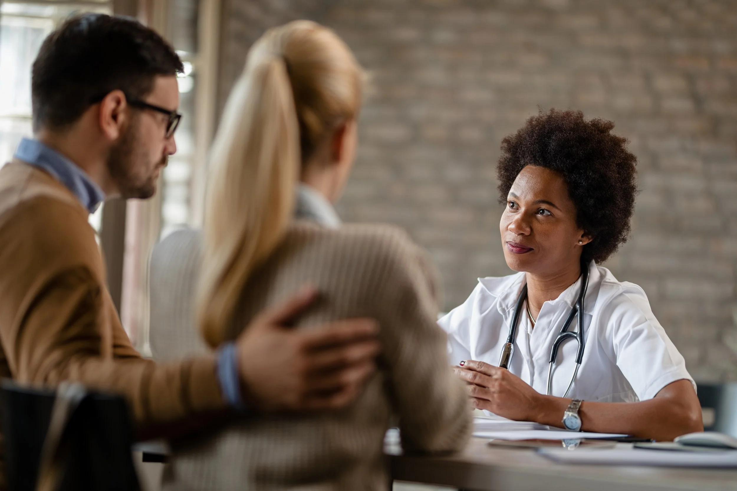 Doctor explains medical information to a couple