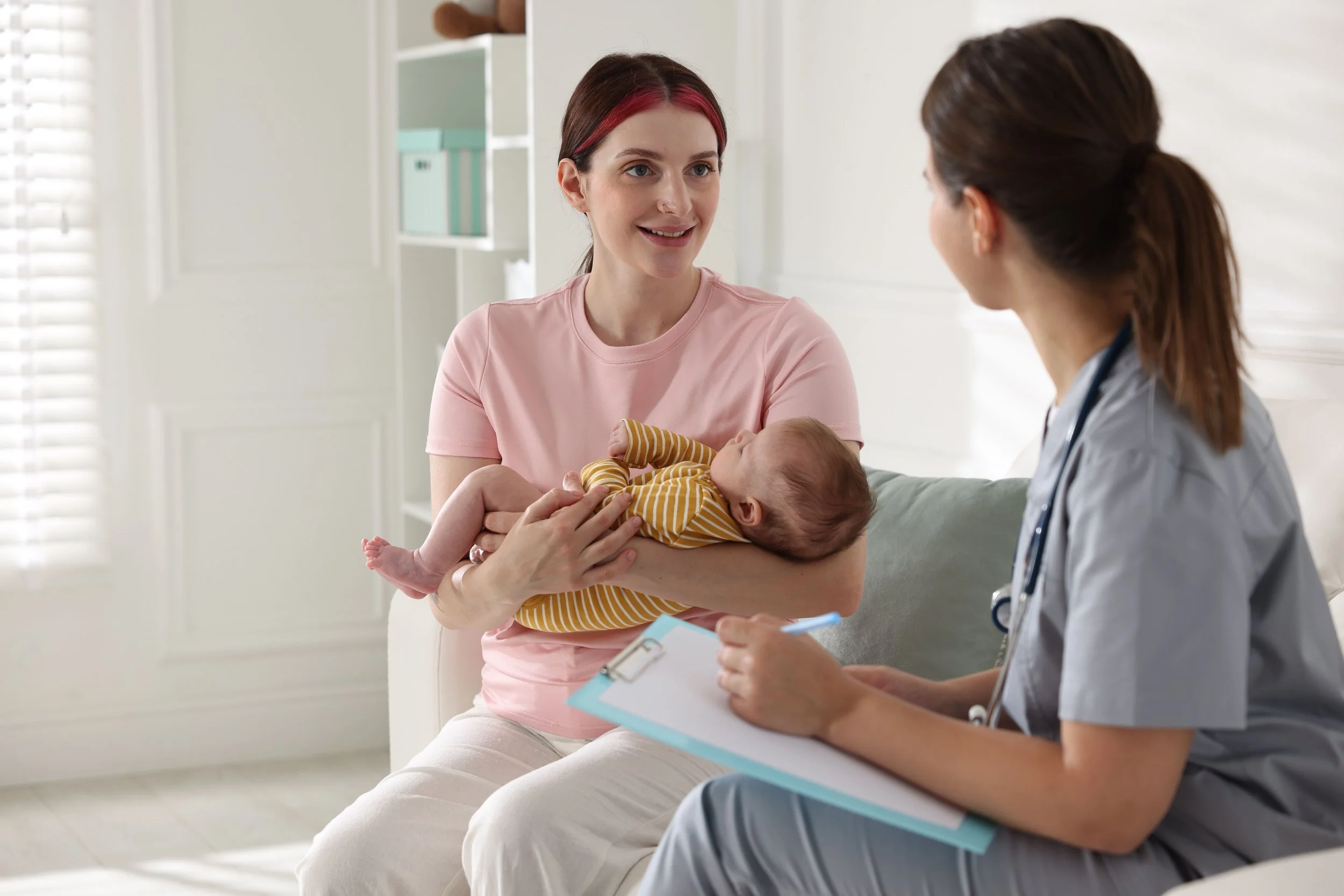 Nurse explains things to a new mother