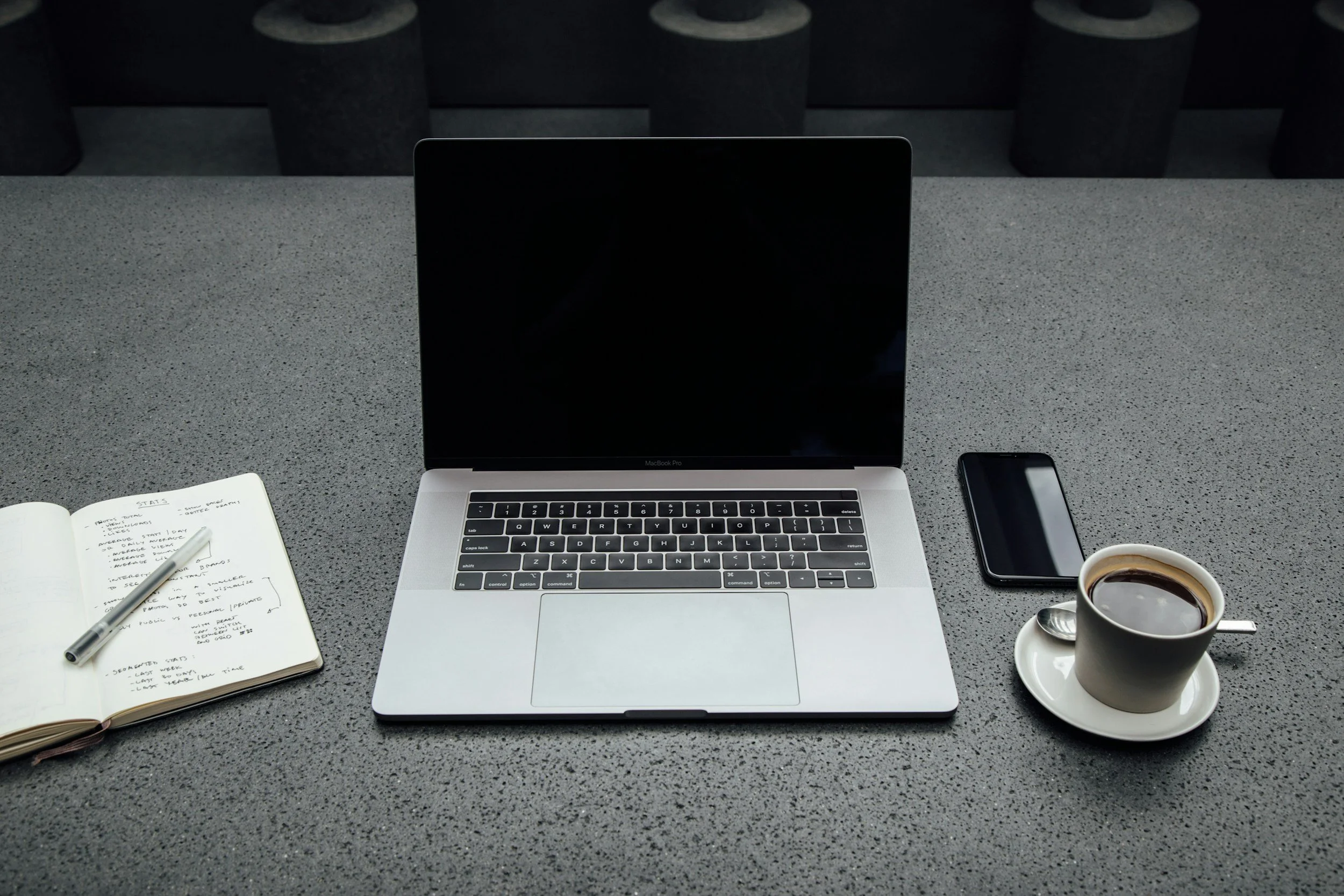 Workspace with laptop and notebook used for online clinical psychology and telehealth therapy sessions.