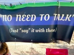 Sign with text 'no need to talk' and '(Just "say" it with these)'.