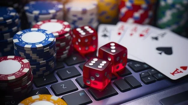 Red Dice, playing cards  & Chips on a computer keyboard