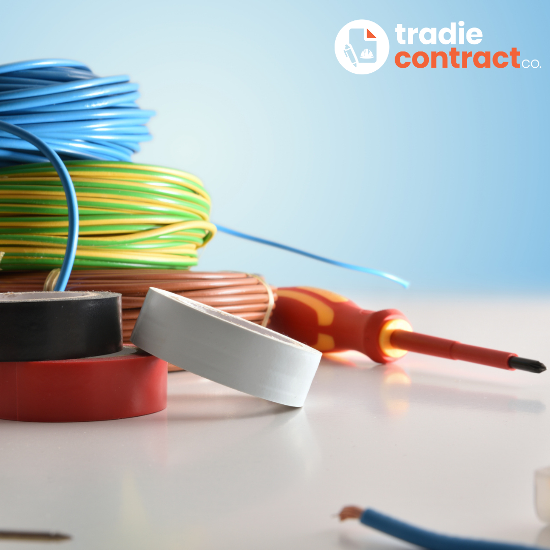 Spools of electrical wires in blue, green, yellow, and red, with black, white, and red electrical tape rolls, and a multimeter screw head on a white surface with a plain light blue background.