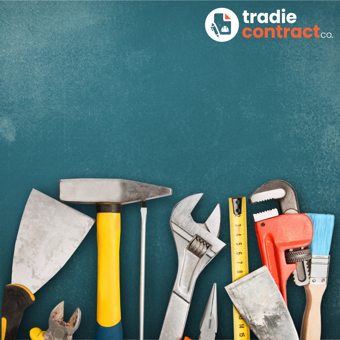 A variety of hand tools including a trowel, hammer, wrench, measuring tape, pipe wrench, file, screwdriver, paintbrush, and pliers arranged on a blue surface with a Trades Contract Co branding in the top right corner.