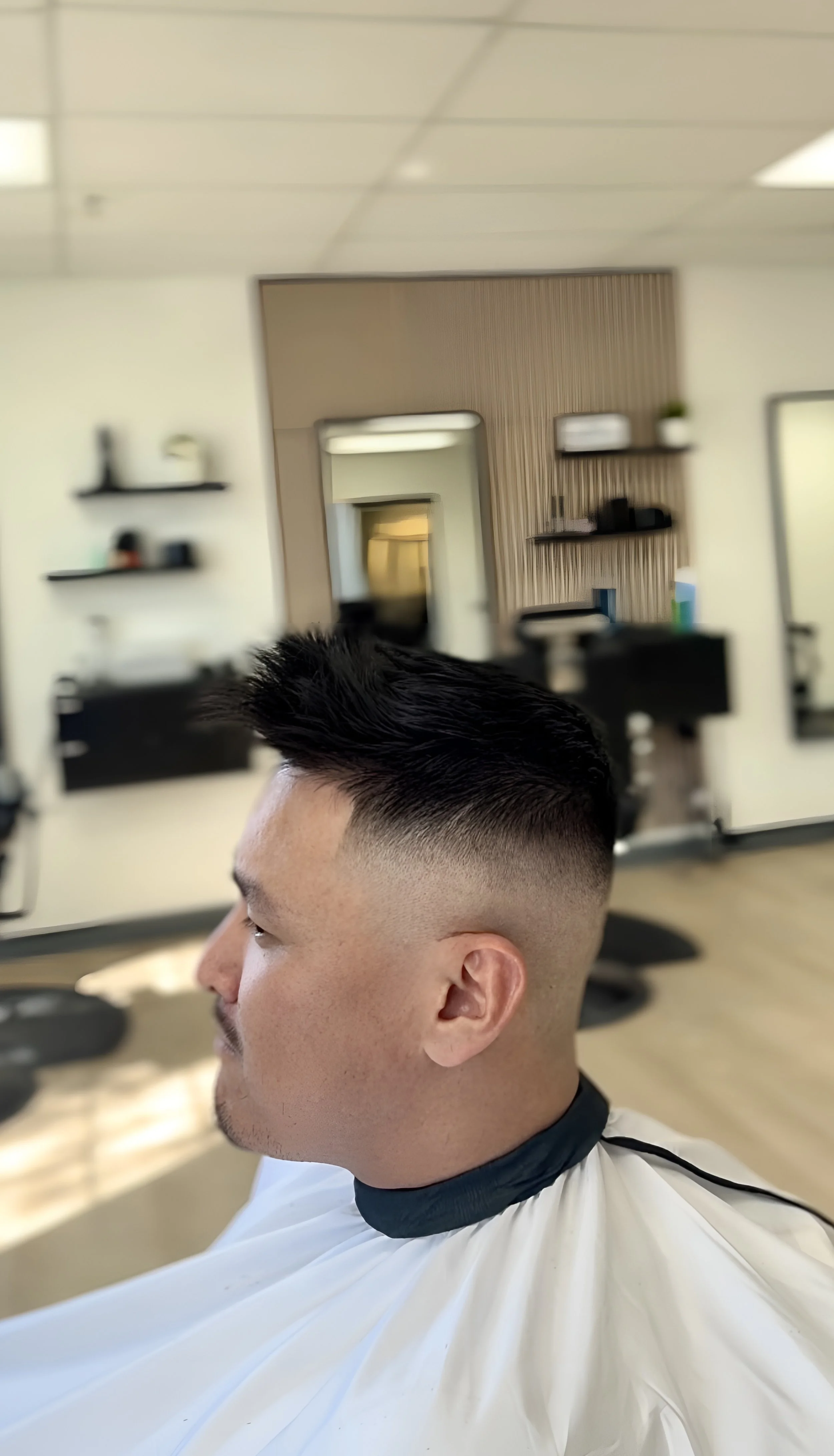 mid skin fade, slight trim on top.