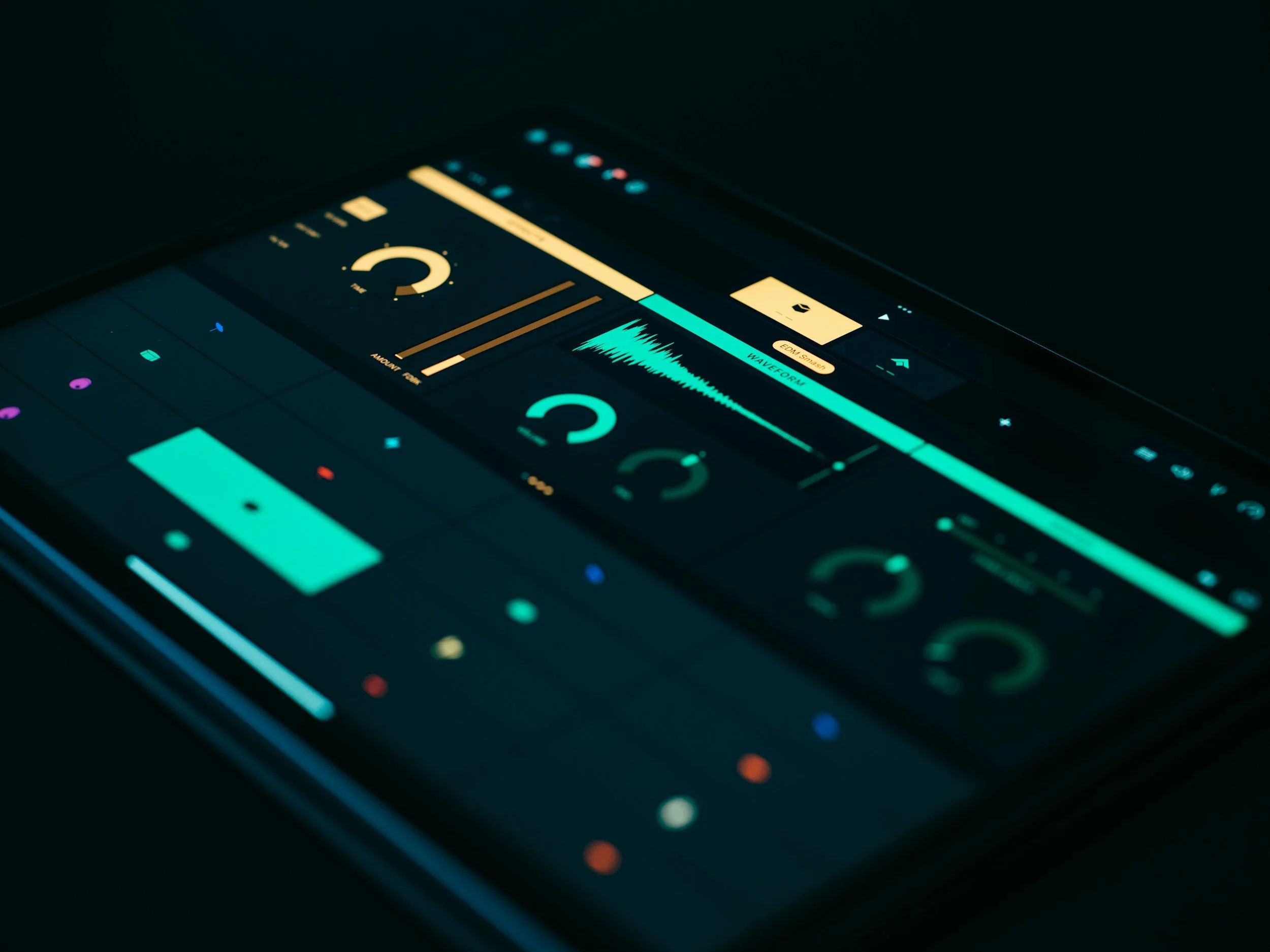 A smartphone displaying a digital audio editing or mixing app with various controls, waveforms, and meters in a dark setting.