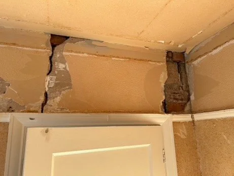 CRACKS IN WALL ABOVE DOOR BEFORE