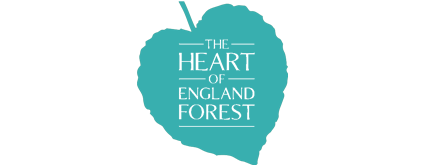 A teal apple-shaped sign with the text "The Apple of Your Eye" in black.