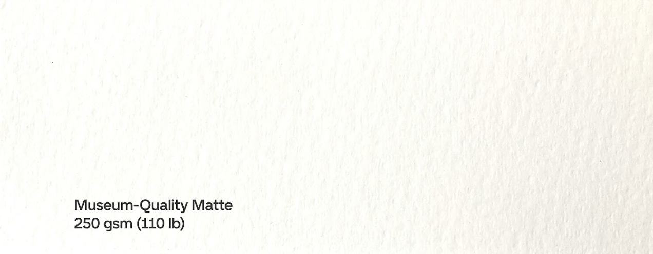 Close-up of textured matte paper with label indicating its weight as 250 gsm or 110 lb.