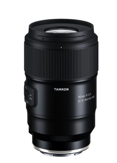 Close-up of a black Tamron 90mm f/2.8 Di III Macro lens against a black background.