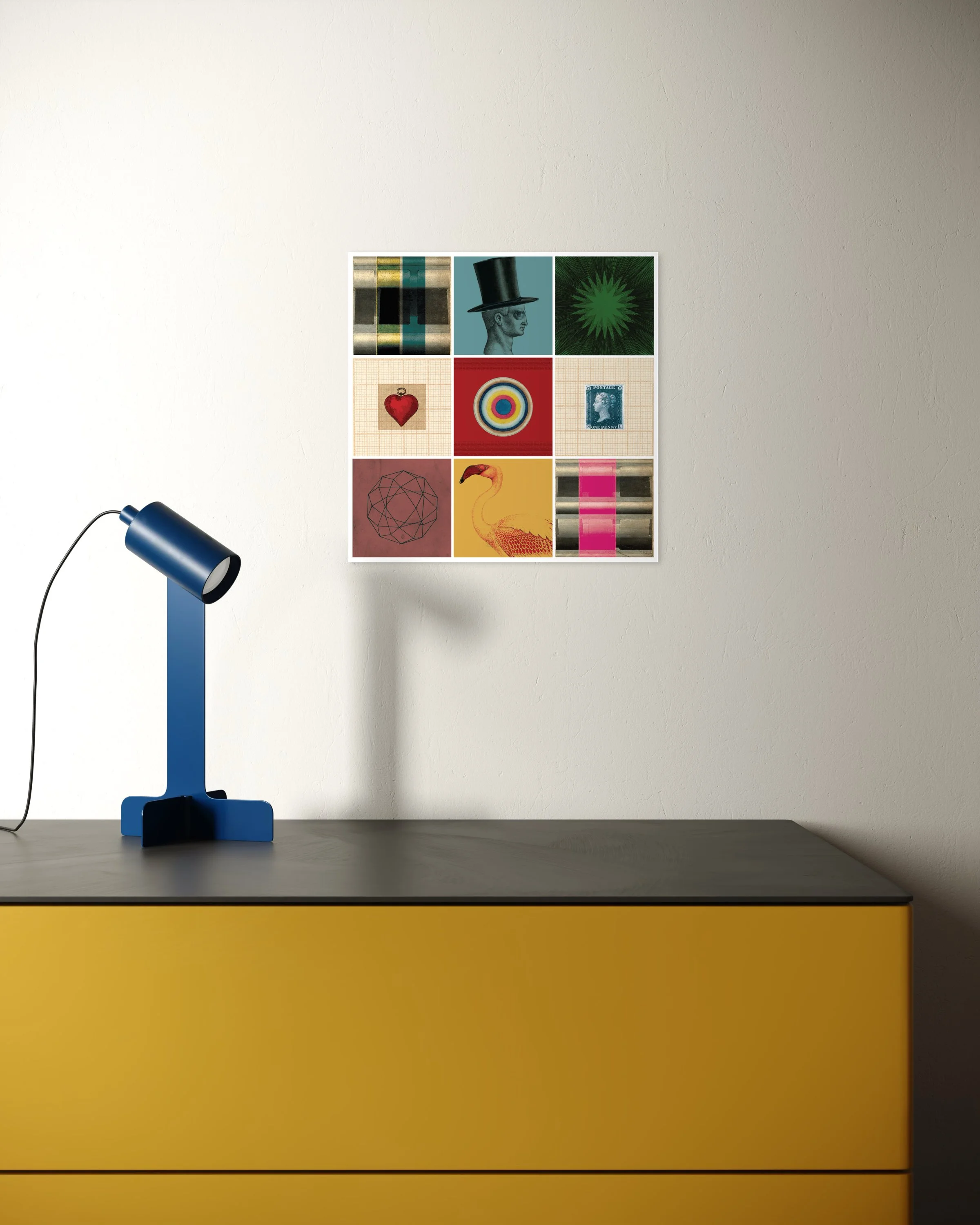 Curiosity collage print displayed unframed on a light wall above a yellow cabinet with a blue desk lamp to the left, in a clean, modern interior.