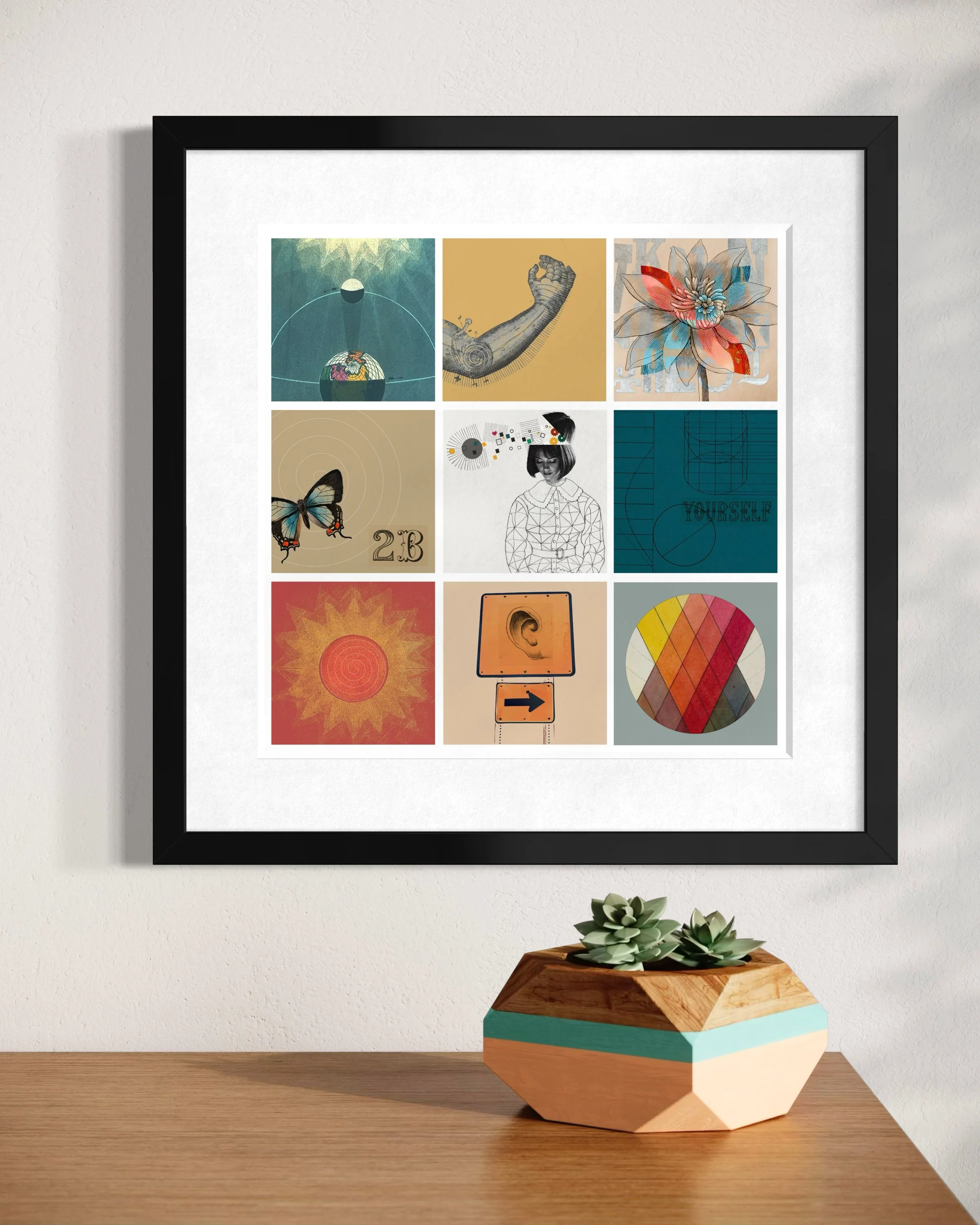 Fragments collage print in a black frame hanging on a light wall above a geometric wooden planter with succulents, styled in a bright modern interior.