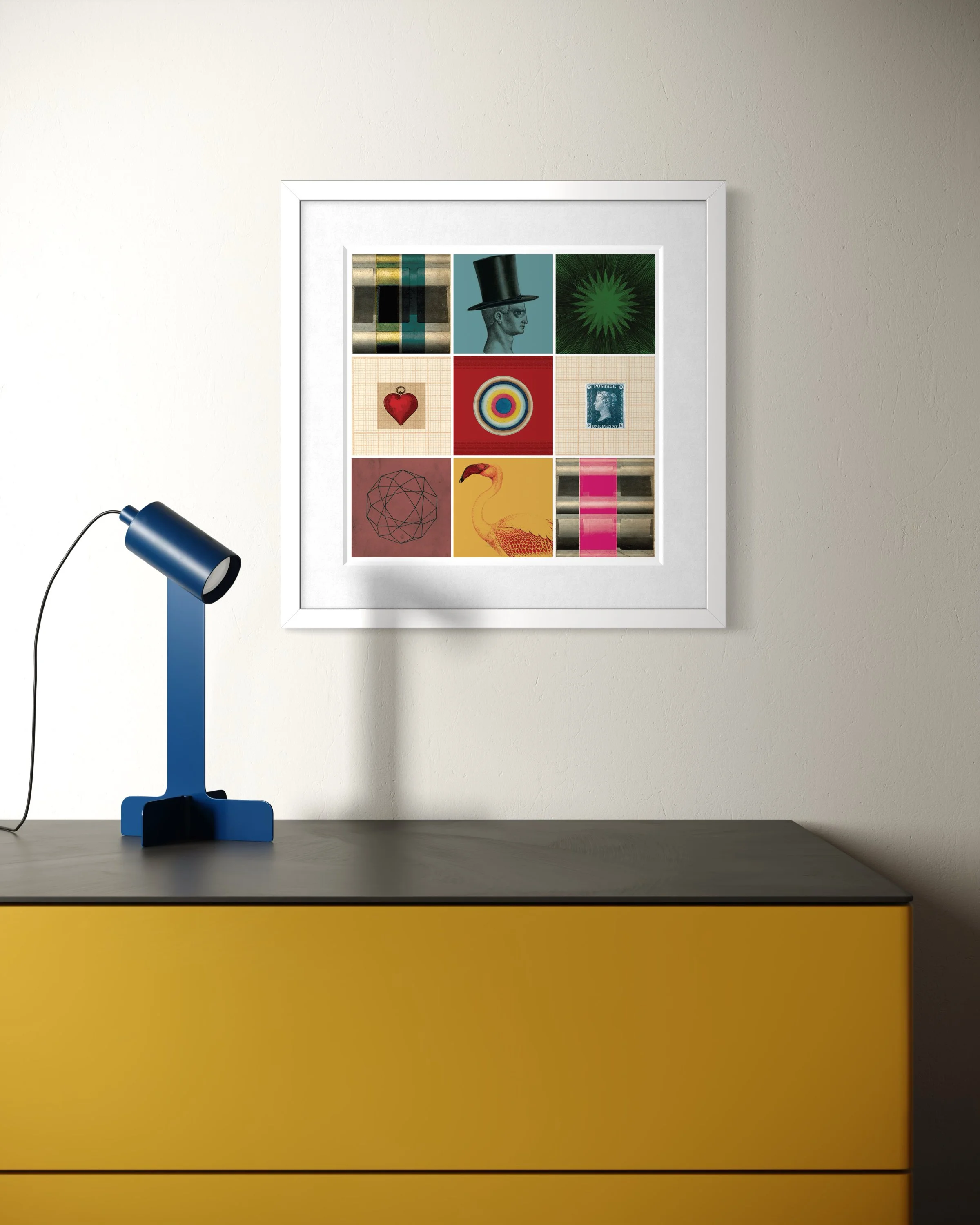 Curiosity collage print in a white frame hanging above a yellow cabinet, paired with a blue modern desk lamp casting a shadow across the wall.