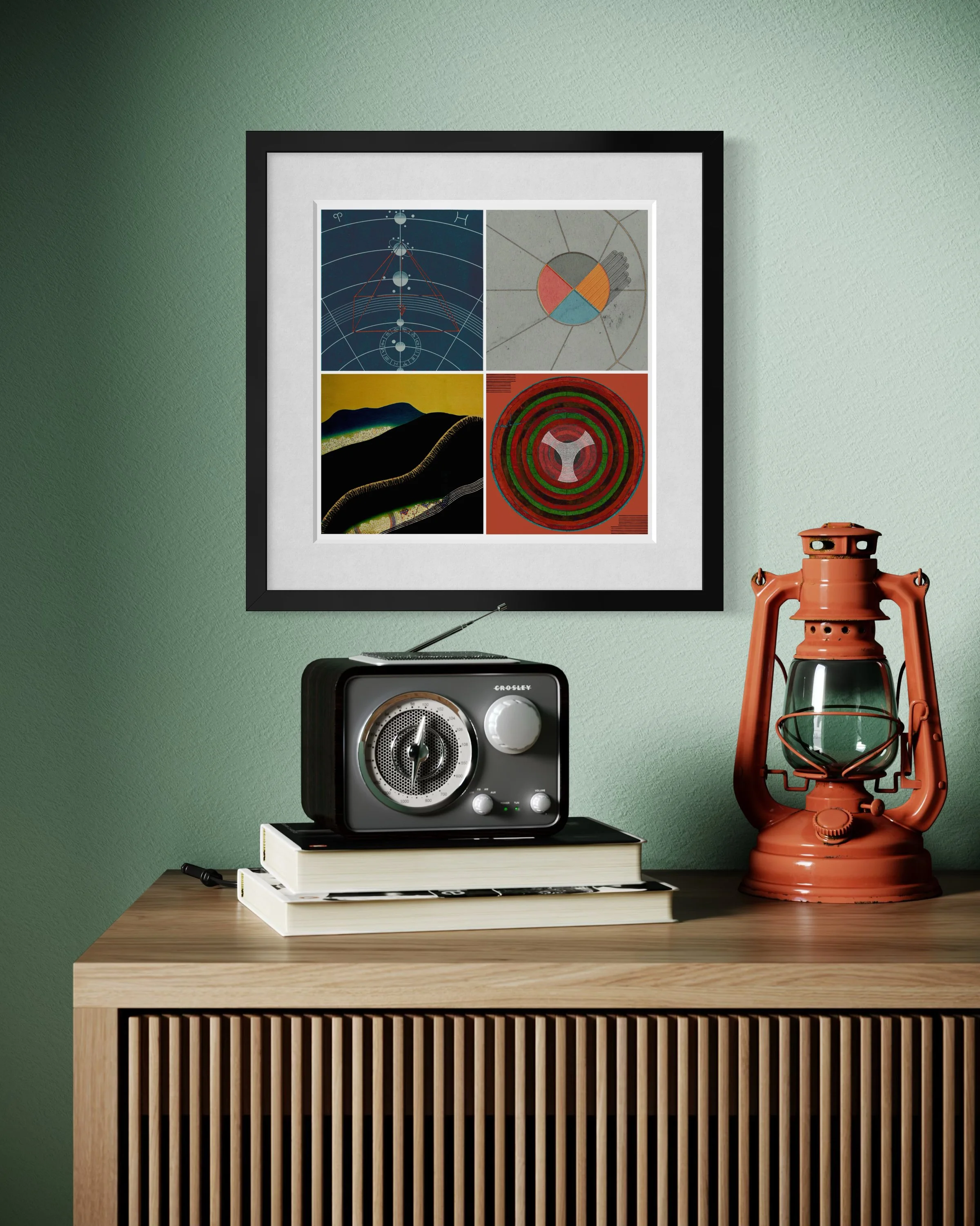 Ceremony fine-art print in a black gallery frame displayed on a mint-green wall above a wooden surface with a vintage radio, stacked books and an orange lantern