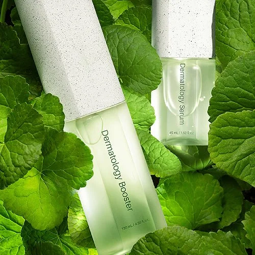 Two bottles of RIMAN Dermatherapy skincare products, surrounded by green leaves, with one labeled 'Dermatherapy Booster' and the other 'Dermatherapy Serum'.