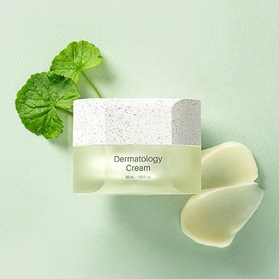 A box of RIMAN dermatology cream with green leaves and sliced aloe vera on a light green background.