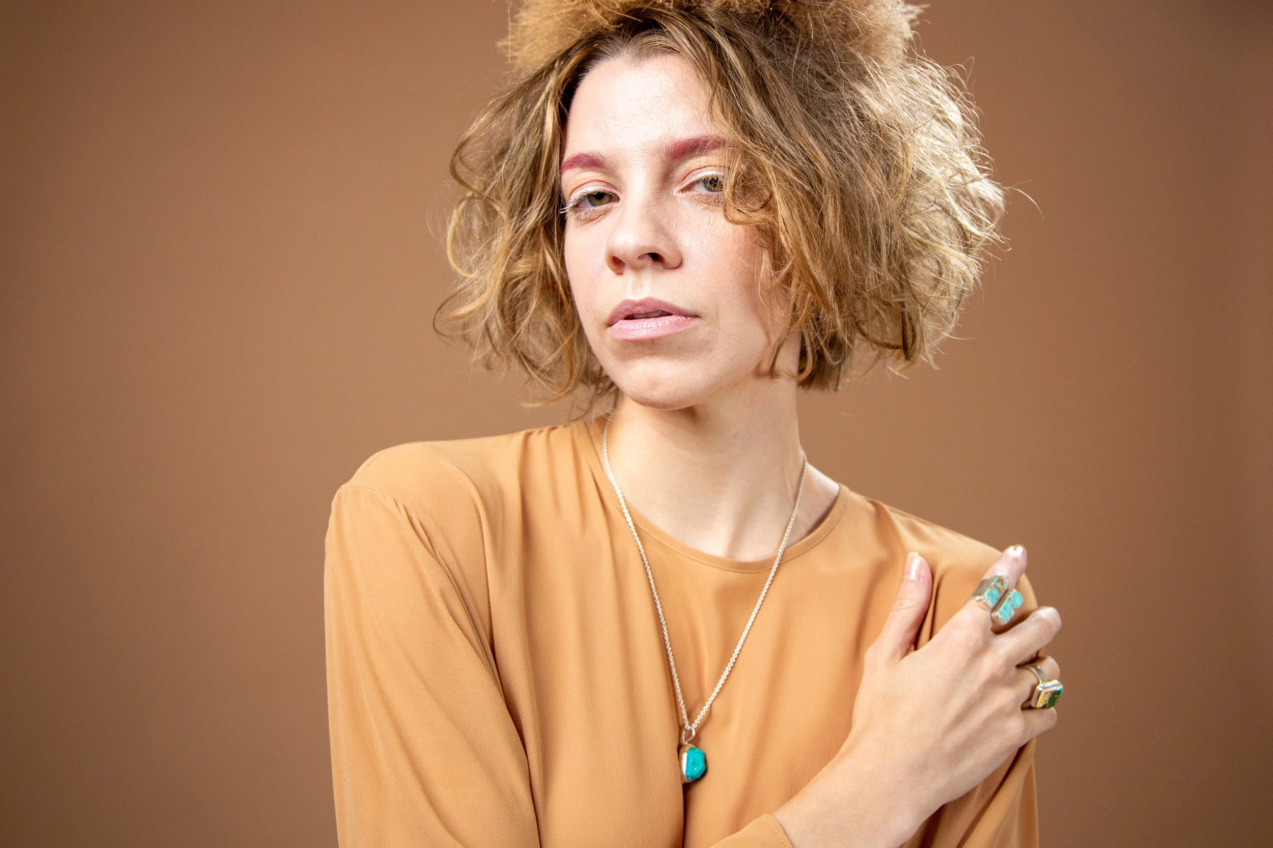 Natural light portrait of model Emory Ä Takagi in warm color palette produced for Sycamore 2025 lifestyle photography