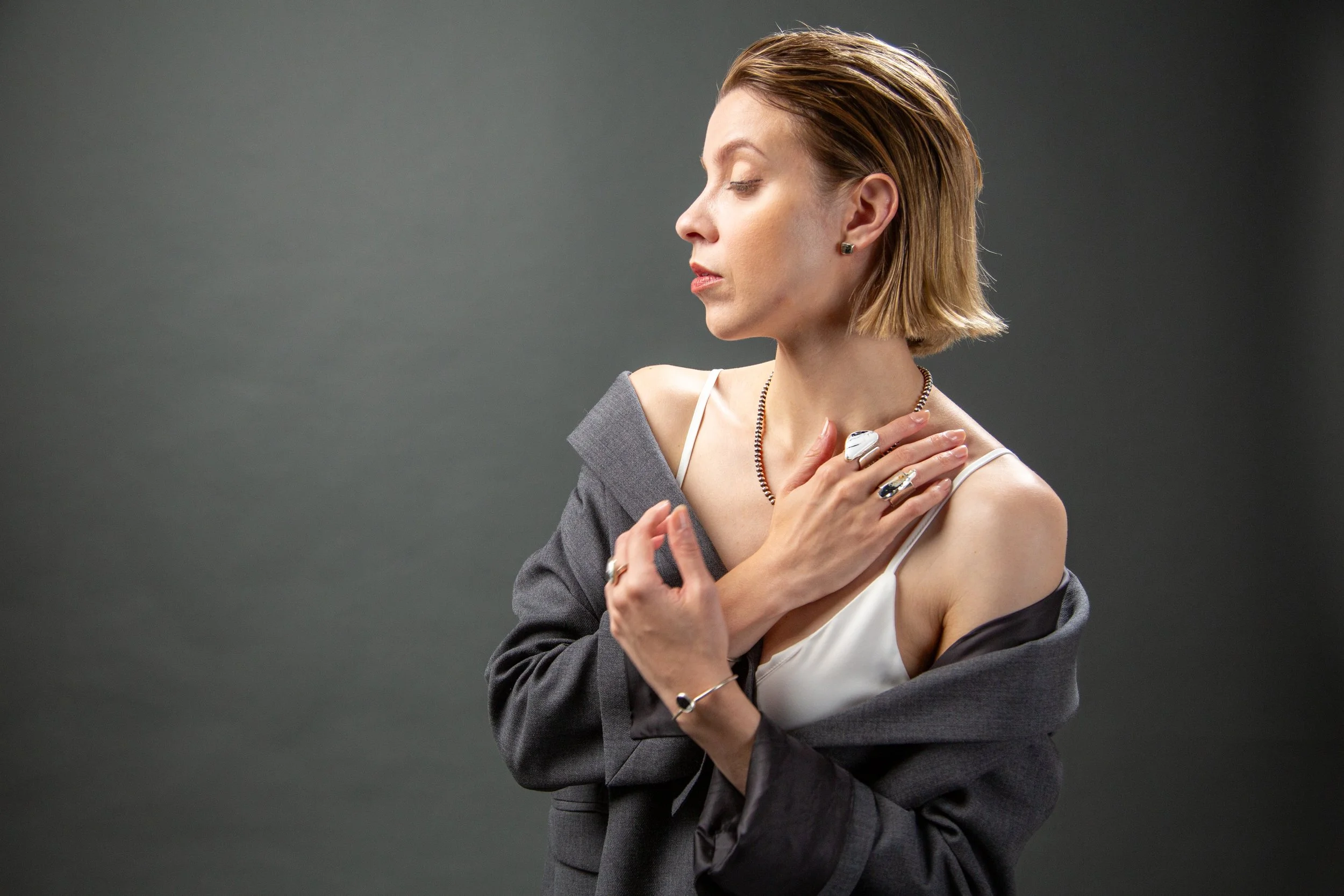 Studio portrait of model Emory Ä Takagi with dramatic side lighting photographed for Sycamore brand identity 2025
