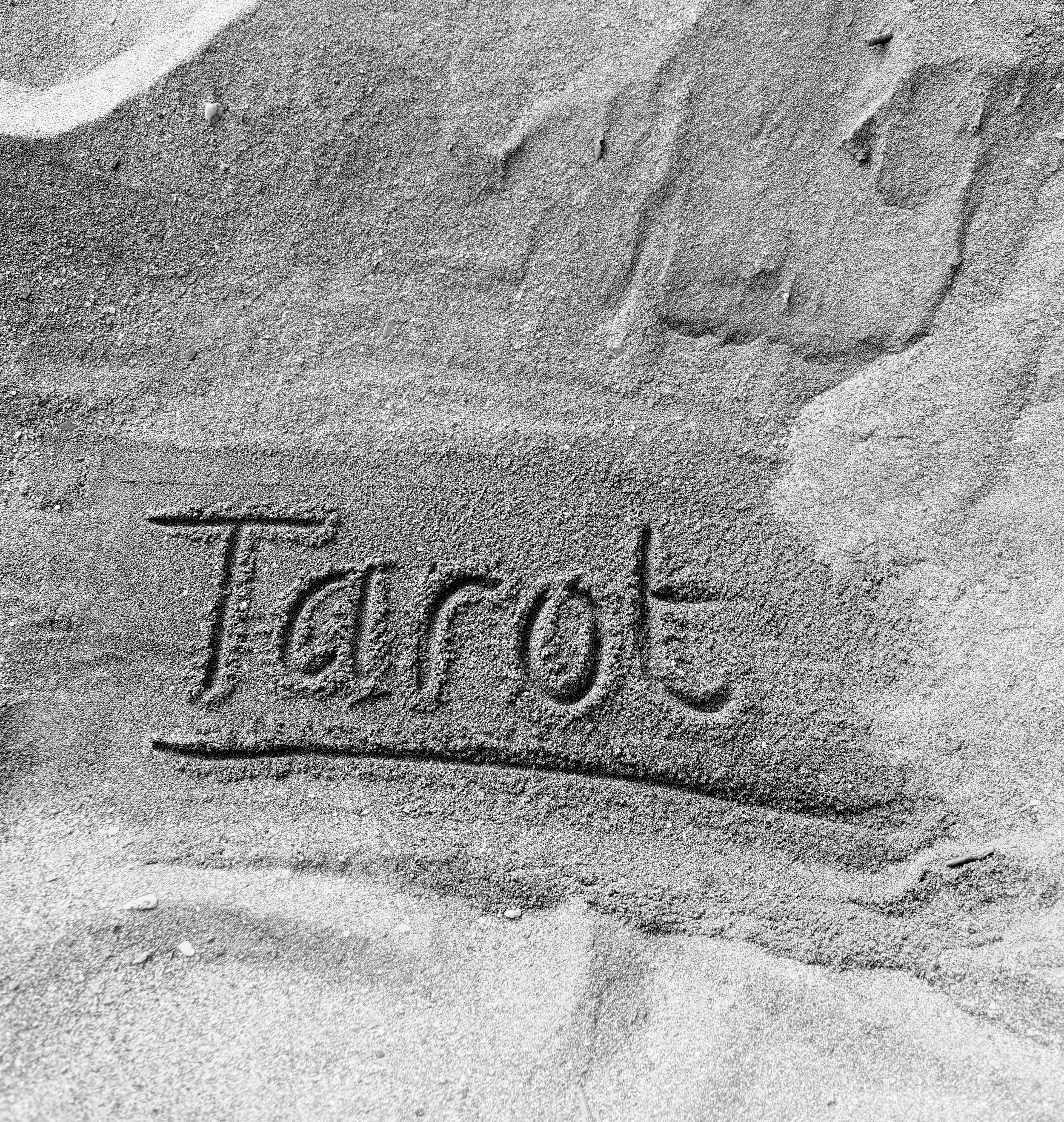 The word Tarot written in the sand, reflecting a practice rooted in presence, clarity, and inner guidance