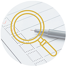Close-up of a pen and a yellow magnifying glass on an answer sheet with multiple-choice bubbles.