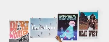 A row of four books with titles: 'Dirt World', 'Freedom', 'Invasion', and 'Head West', displayed on a surface.