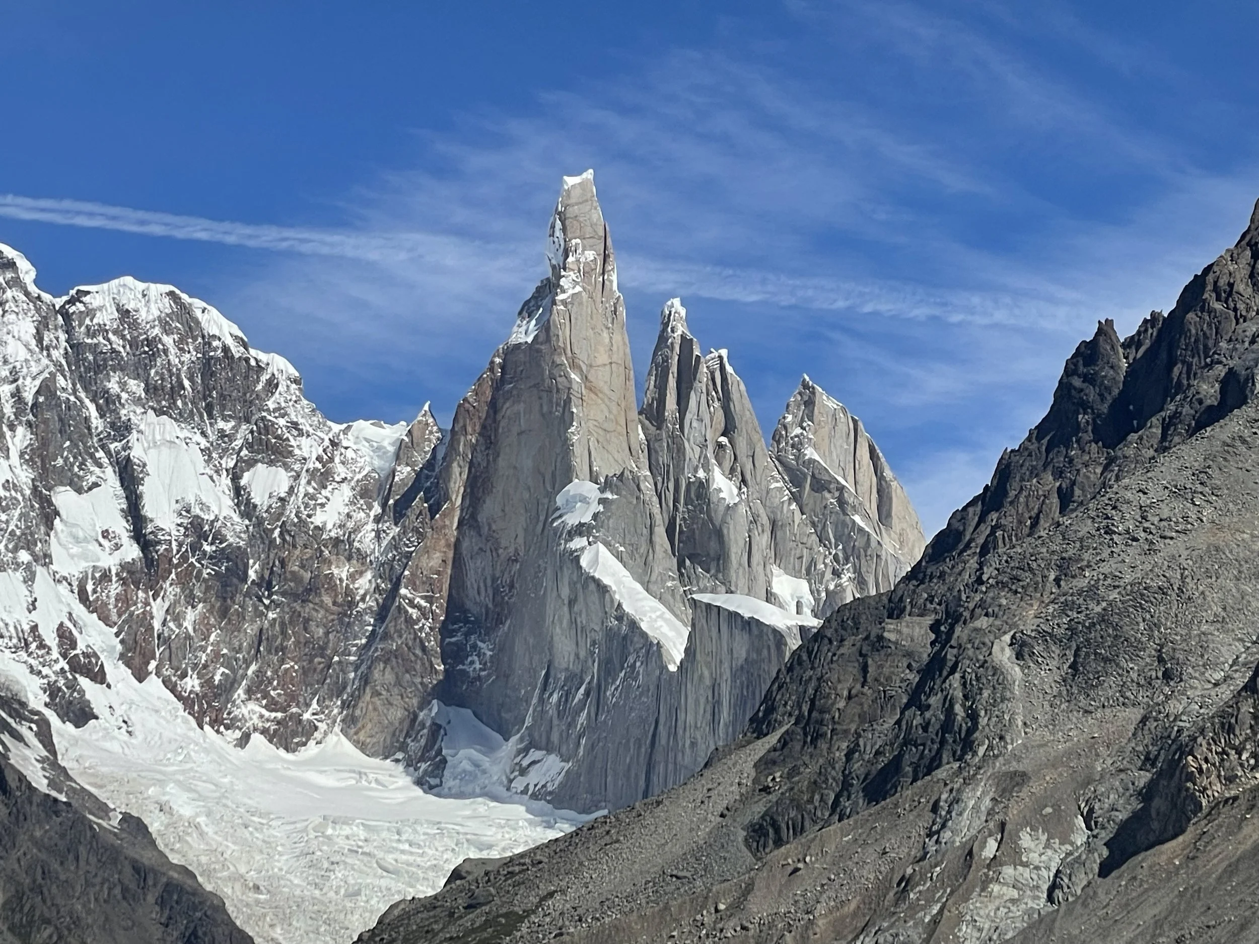 Snow-covered mountain peaks under a clear blue sky.