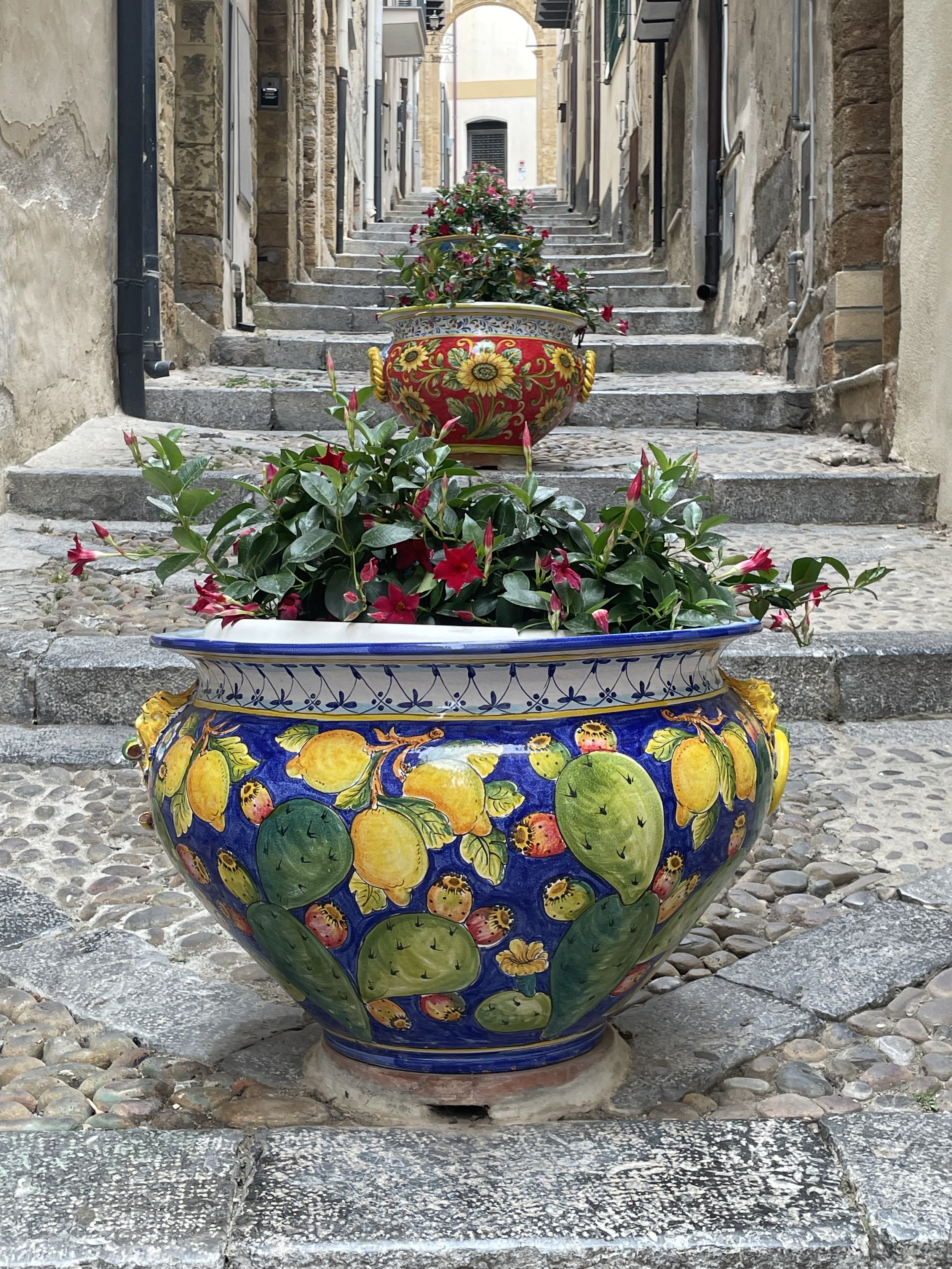 Sicilian scene Cefalu Palermo Painted pots stairway secret alley 
